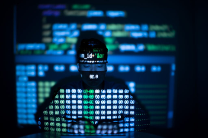 Person typing on a keyboar. Nunmbers and code are being projected on the person.