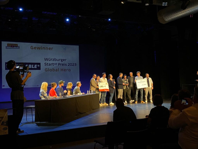 The Eye-Able founders holding the Price on stage.