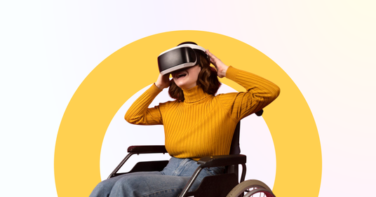 The picture shows a woman in a wheelchair wearing VR glasses.