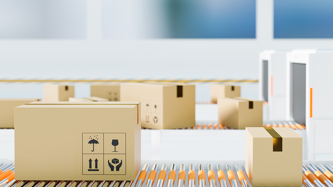 Cardboard boxes moving on a conveyor belt in a logistics center