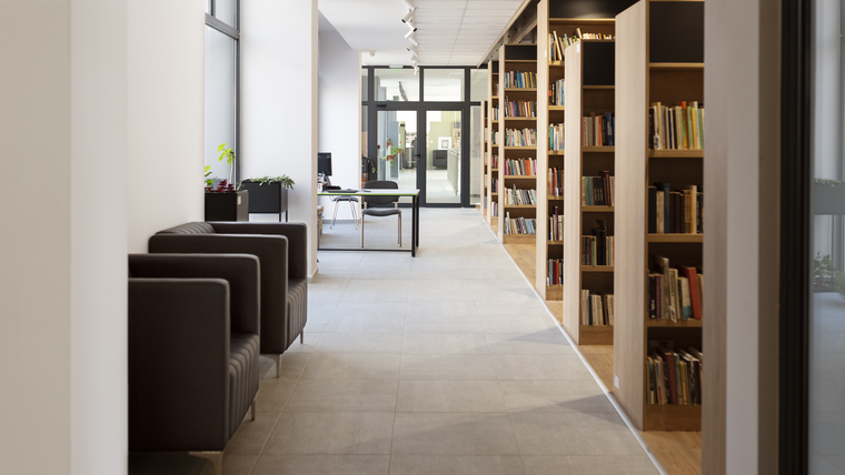 A modern library hallway with bookshelves and seating areas