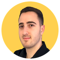 A person with short dark hair, wearing a black shirt, against a solid yellow background.