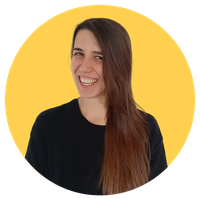 Smiling woman with long brown hair in a black shirt against a yellow circular background.