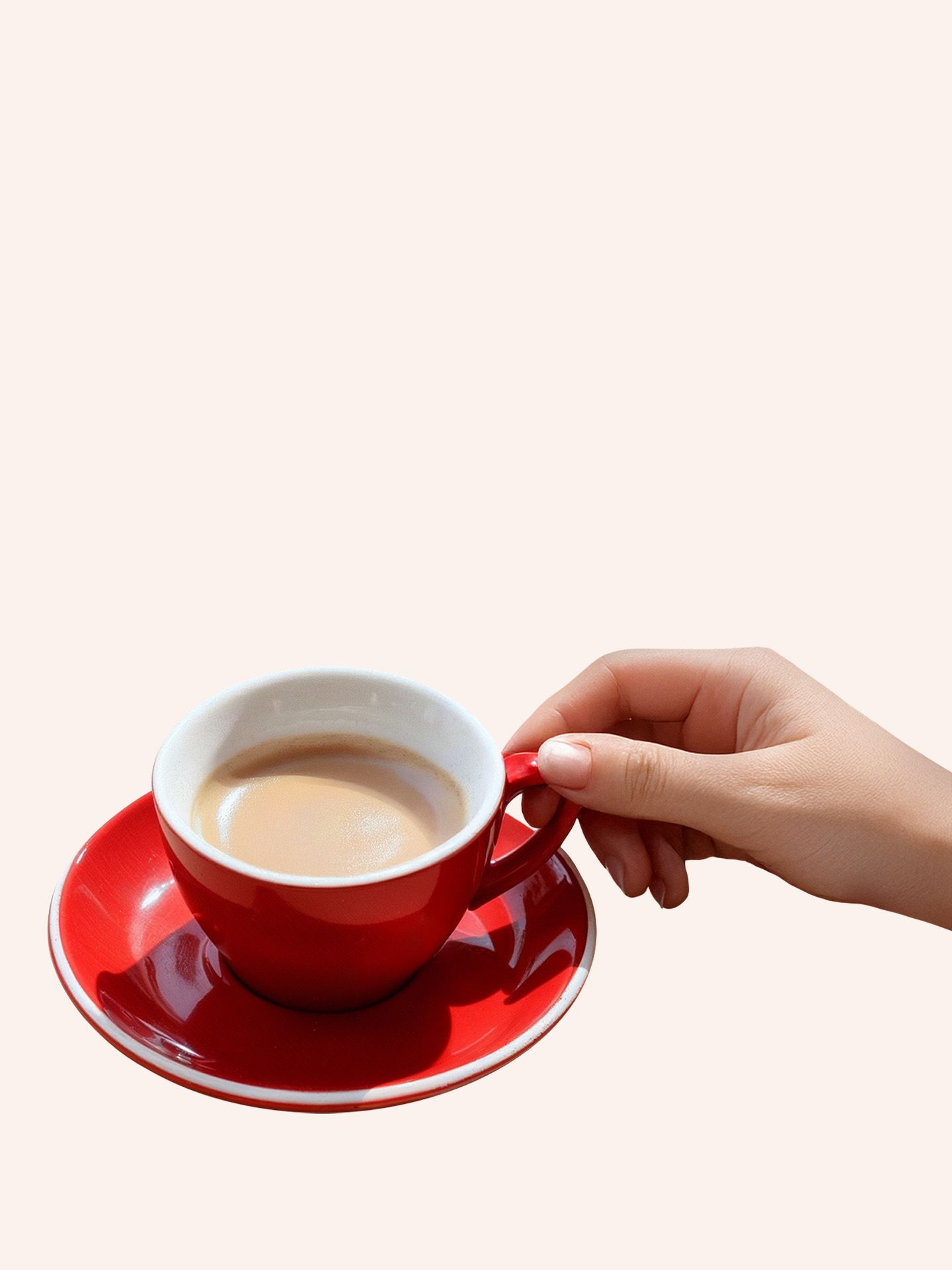 Cup of espresso with hand holding it