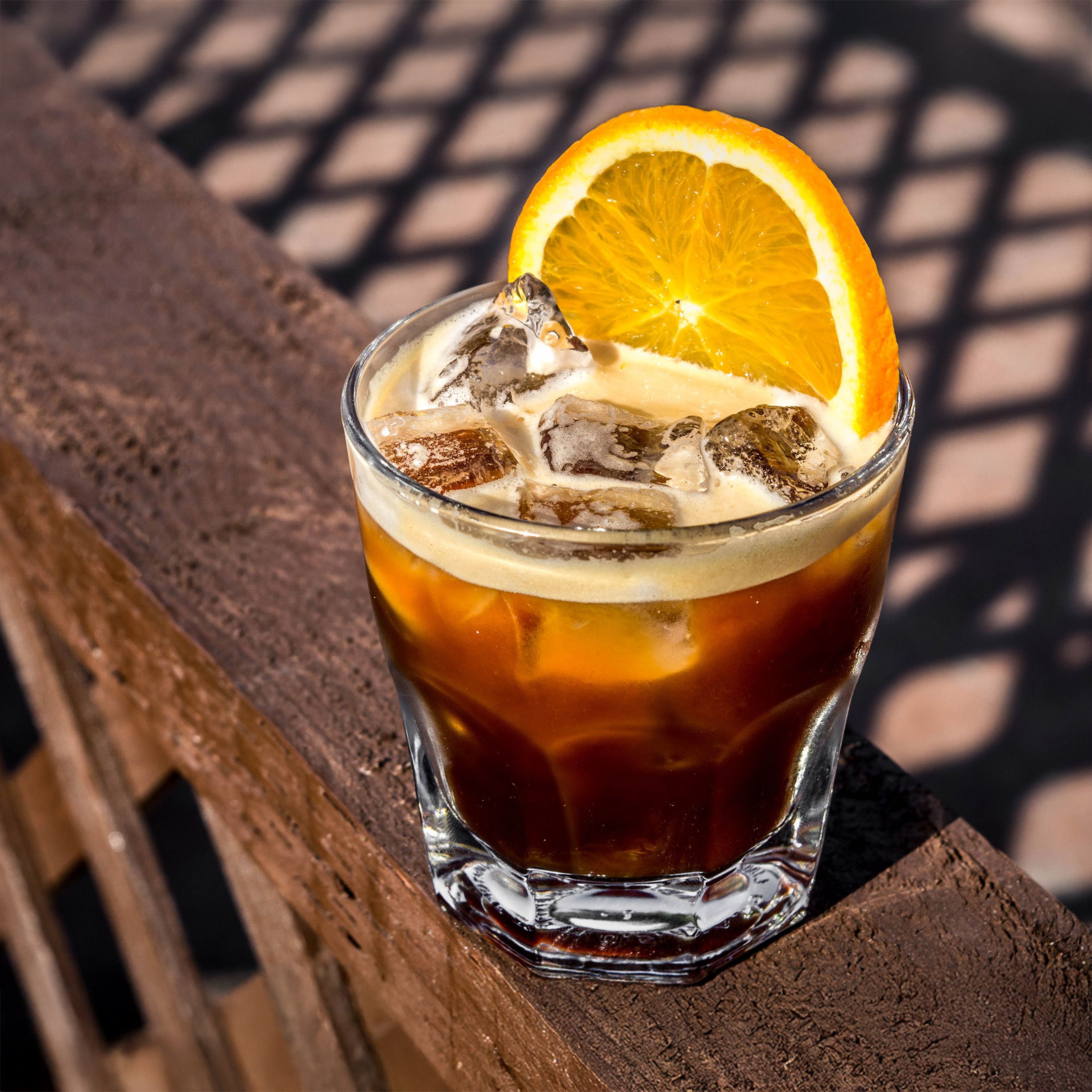 Carajillo cocktail with espresso, Licor 43, orange and ice cubes