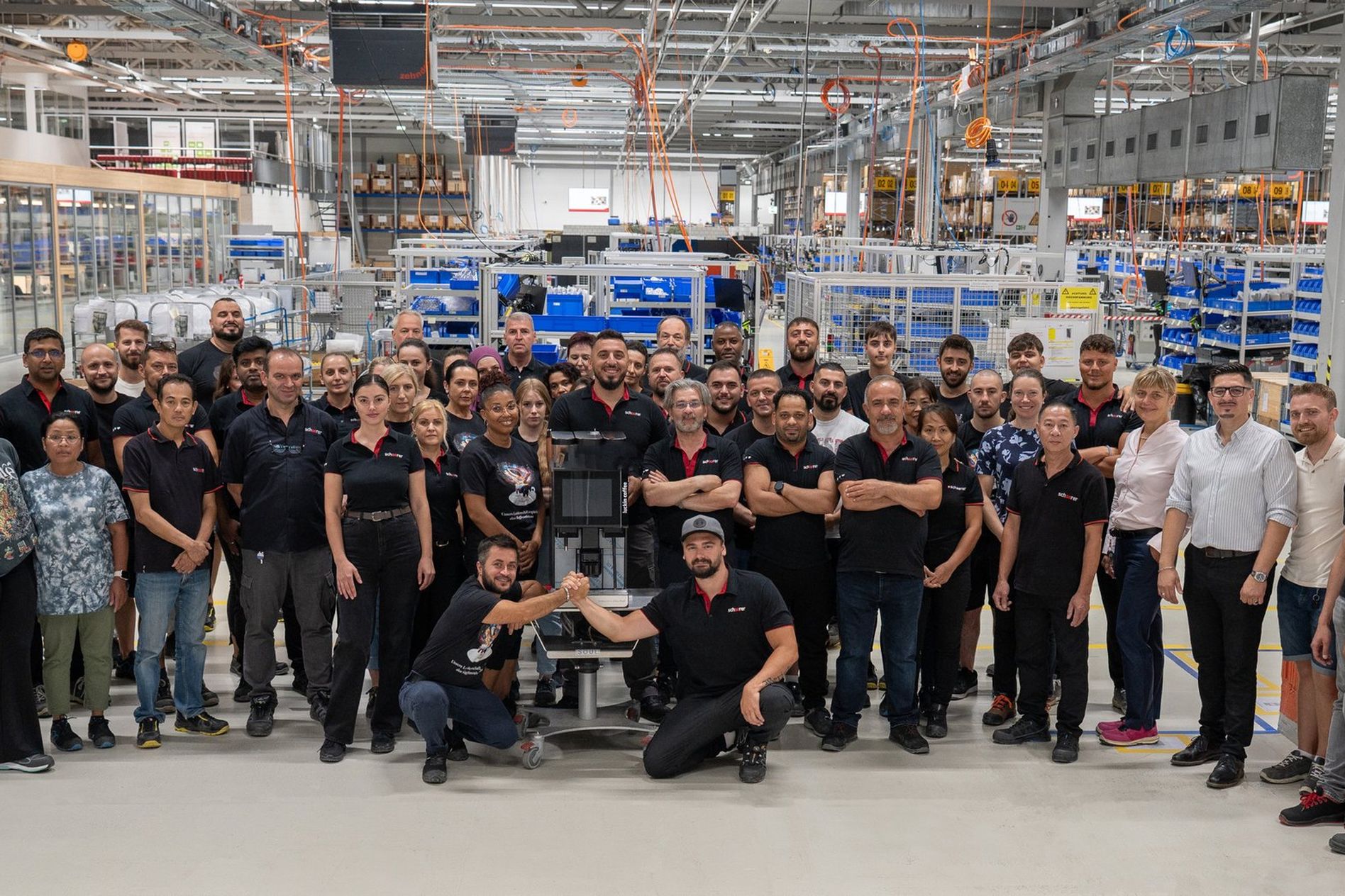 Schaerer employees in production hall with 100,000th Coffee Soul machine