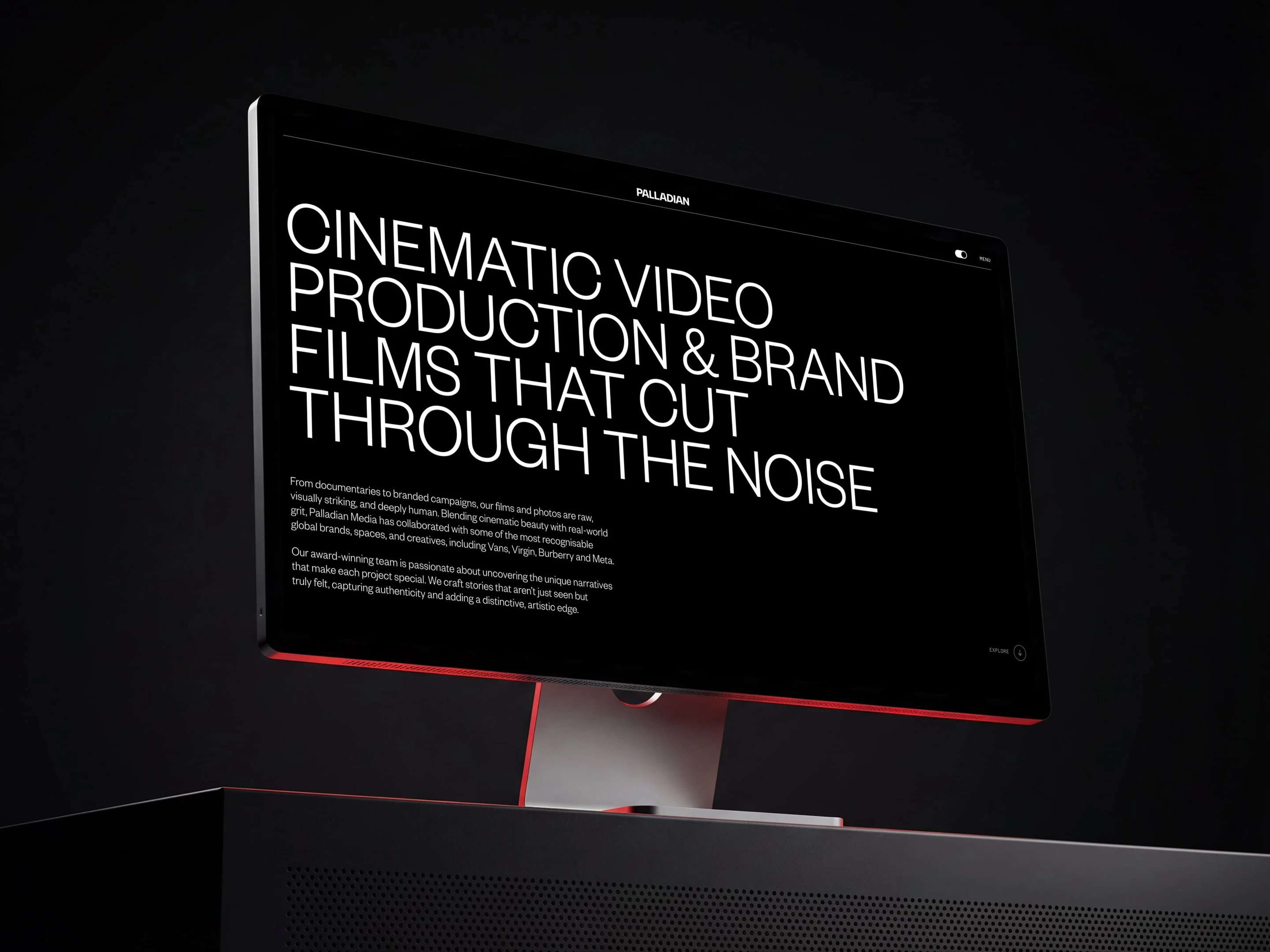Computer screen displaying bold, white text: "Cinematic Video Production & Brand Films That Cut Through the Noise," on a dark background.