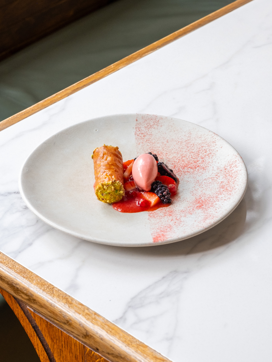 White chocolate and pistachio cannoli with summer berries