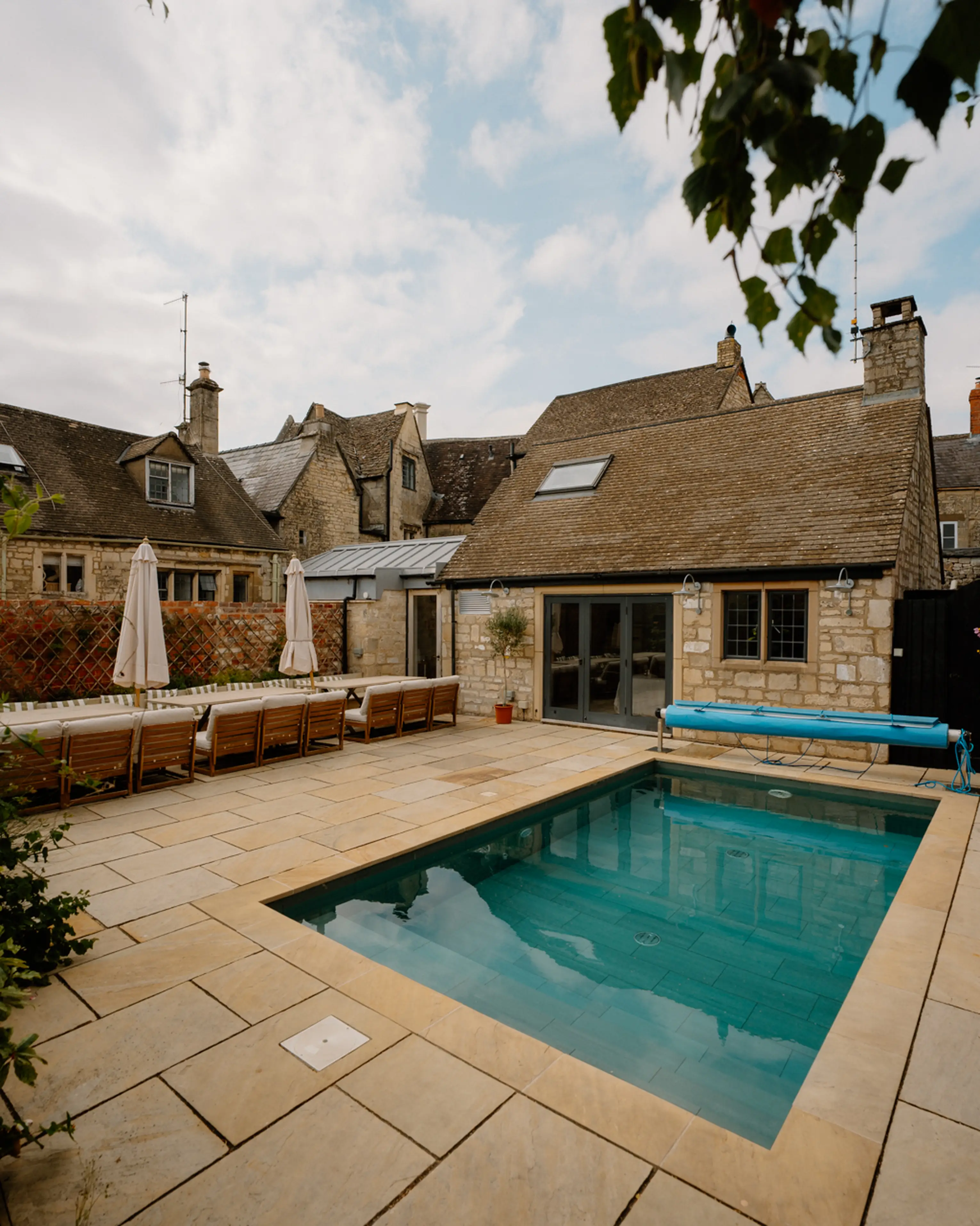 Outdoor pool and stone terrace in the garden at ARC Painswick