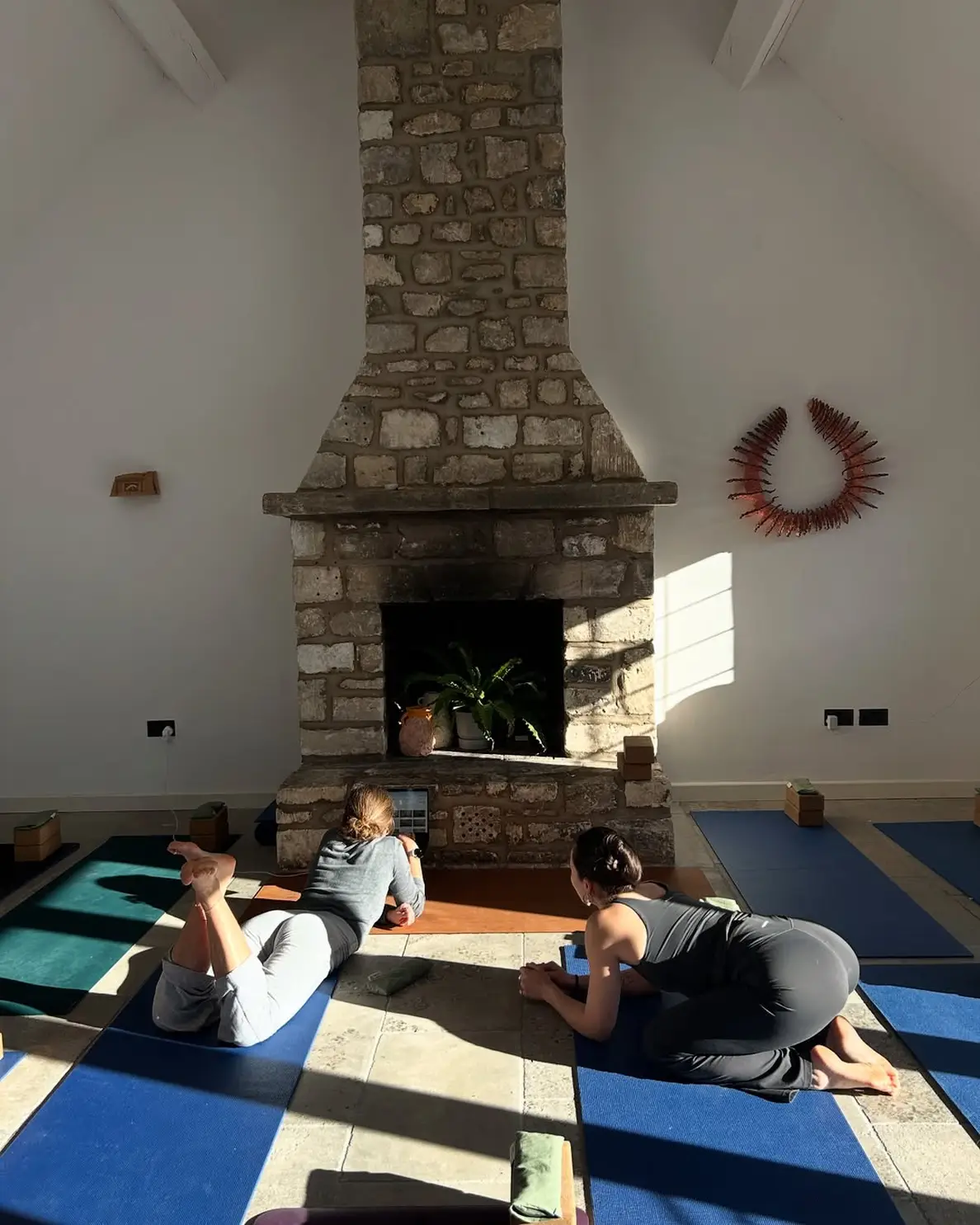 A group staying at ARC Next-the-sea taking advantage of the custom wellness activities and excursions available within the accommodation. Pictured is a guided yoga session.