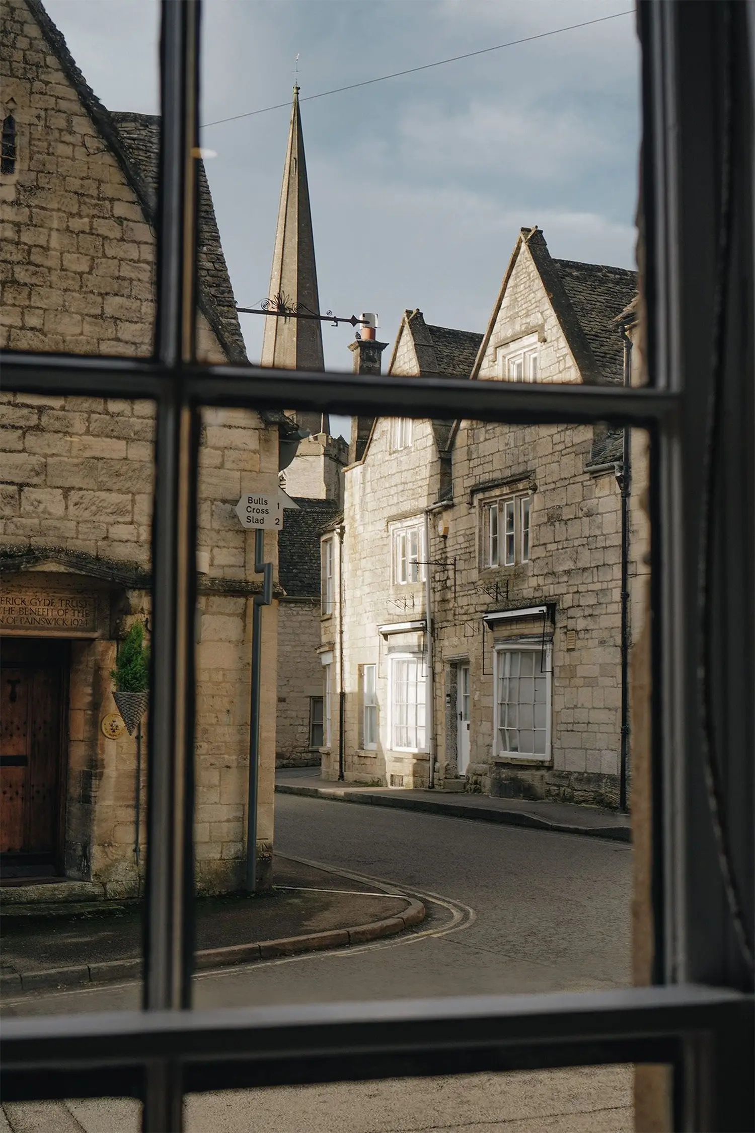 View through a window of ARC Painswick to the Cotswold town groups and visitors staying can explore as part of their holiday accommodation.