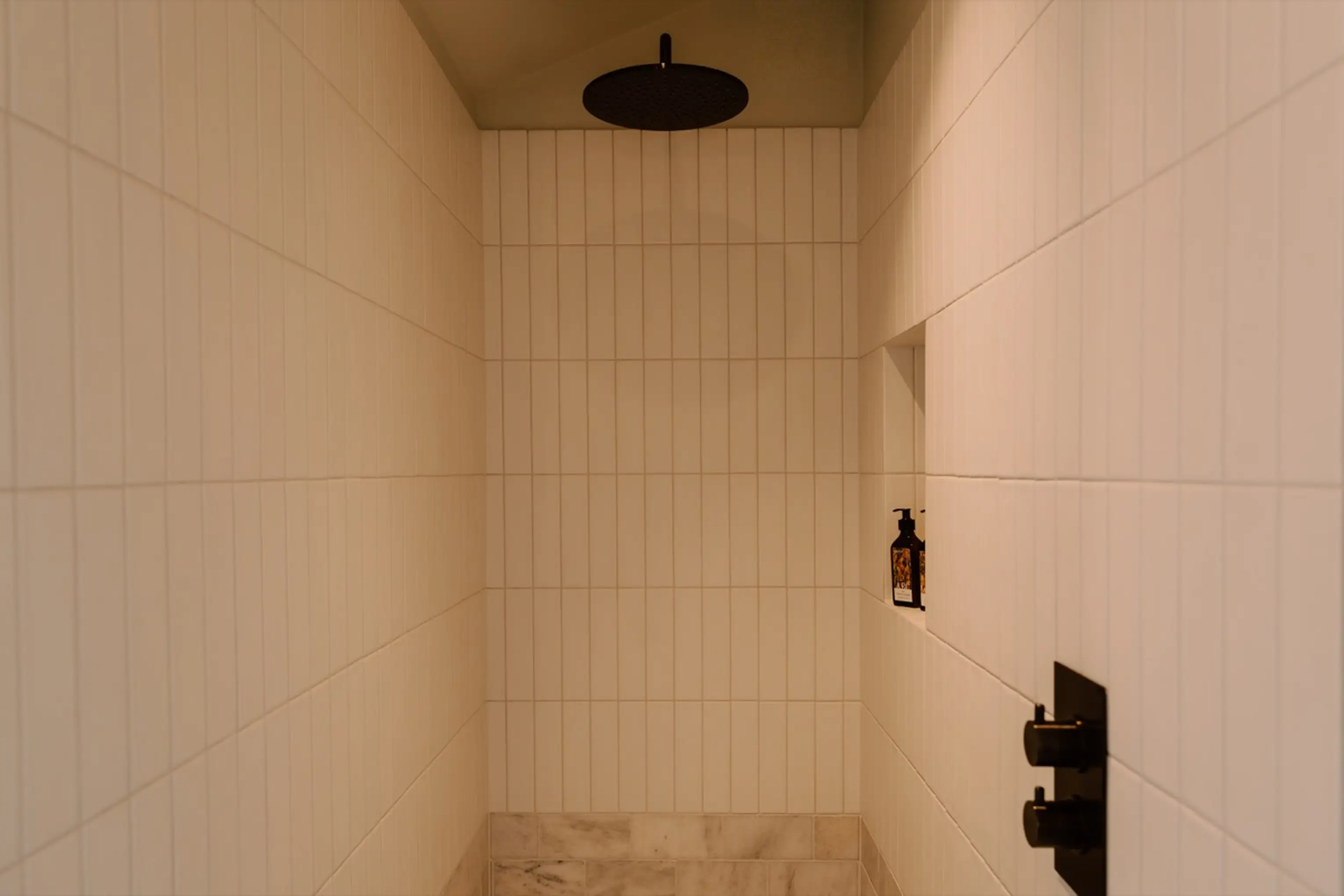 White-tiled walk-in shower under the eaves at ARC Next-the-Sea