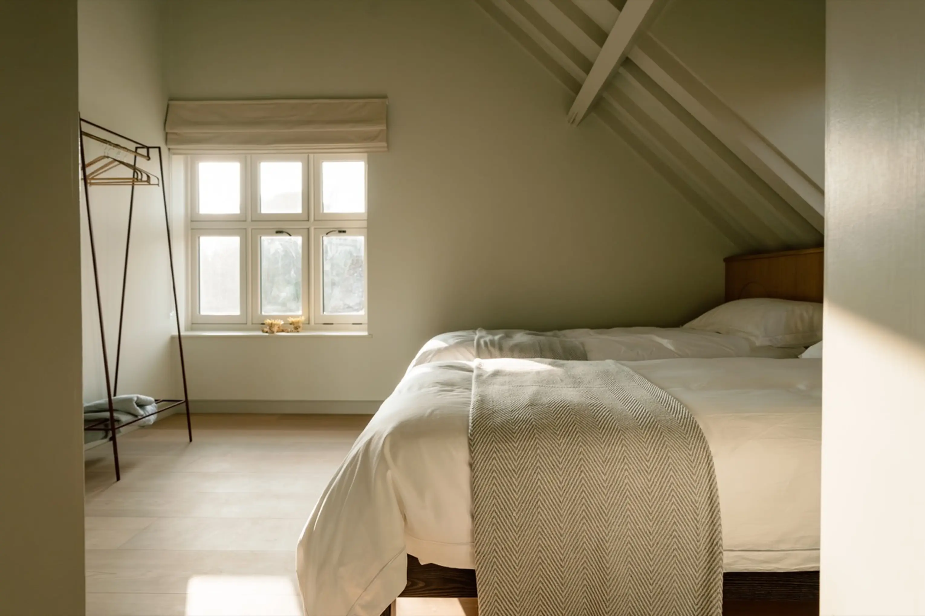 Eaves bedroom at ARC Next-the-Sea with a white bed beside a window