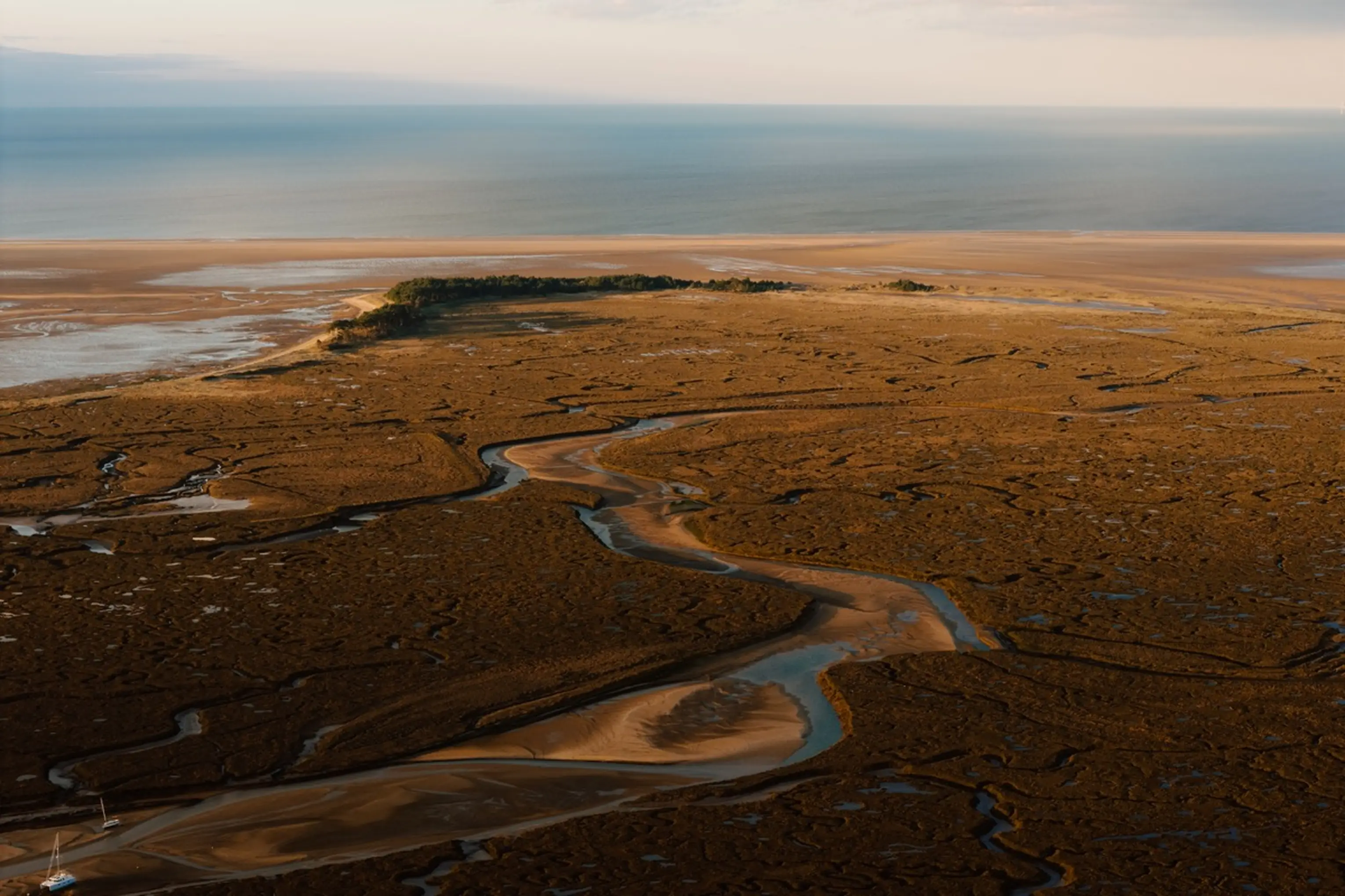 Aerial view over the Wells-next-the-Sea salt marshes and sea at dusk