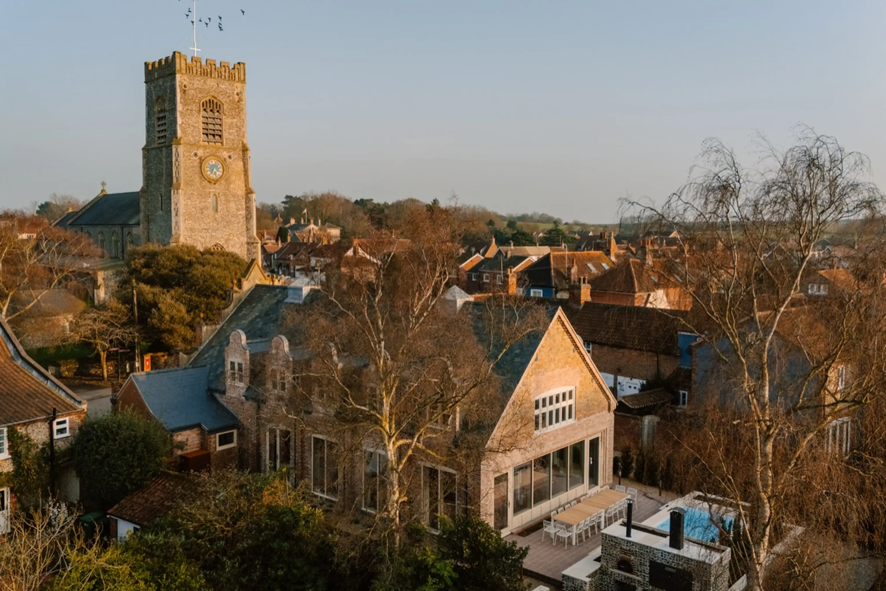 Aerial view of Wells-next-the-Sea village with ARC Next-the-Sea in the foreground and the church tower and rooftops