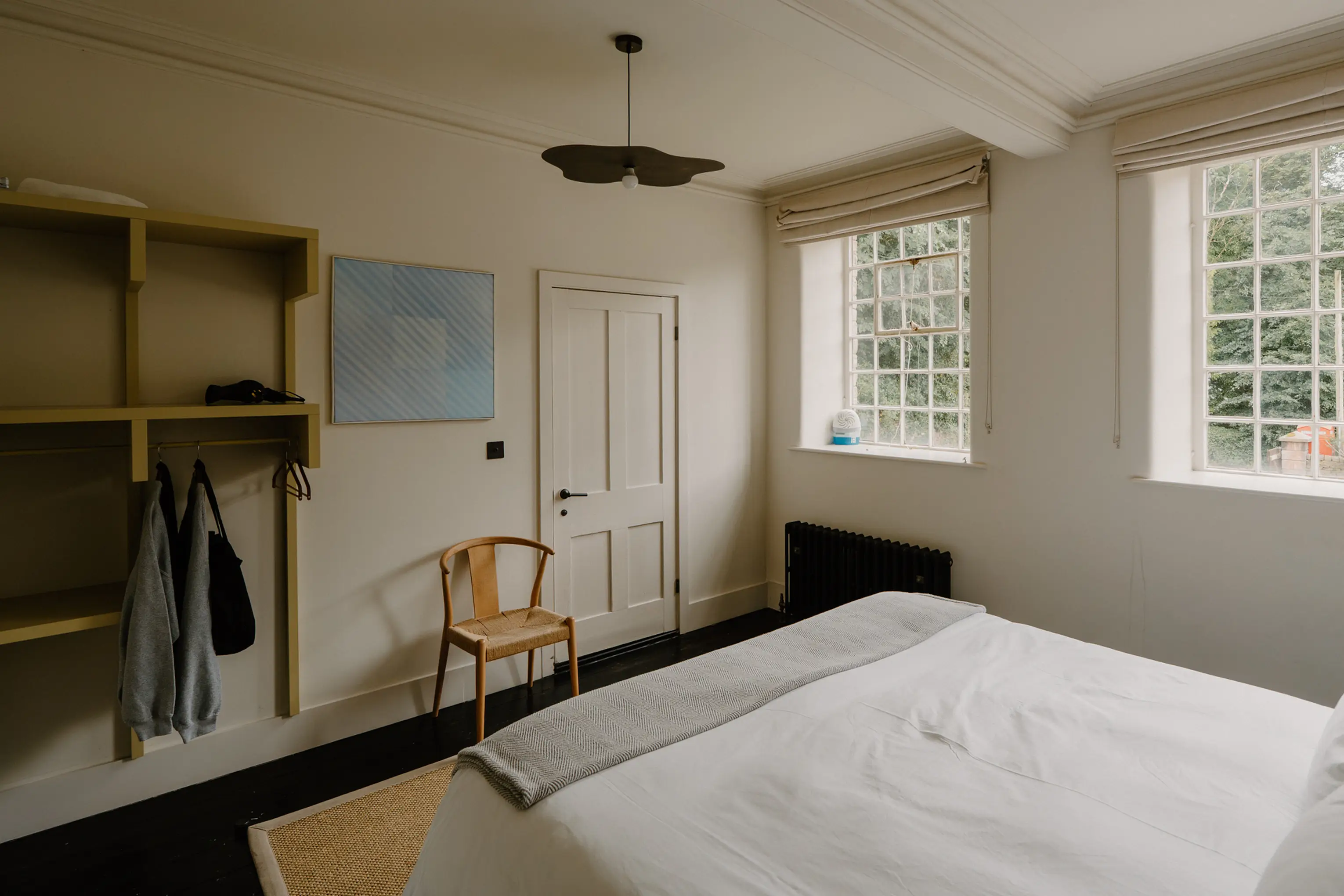 Superking bedroom at ARC Peaks with an open hanging rail and bright windows