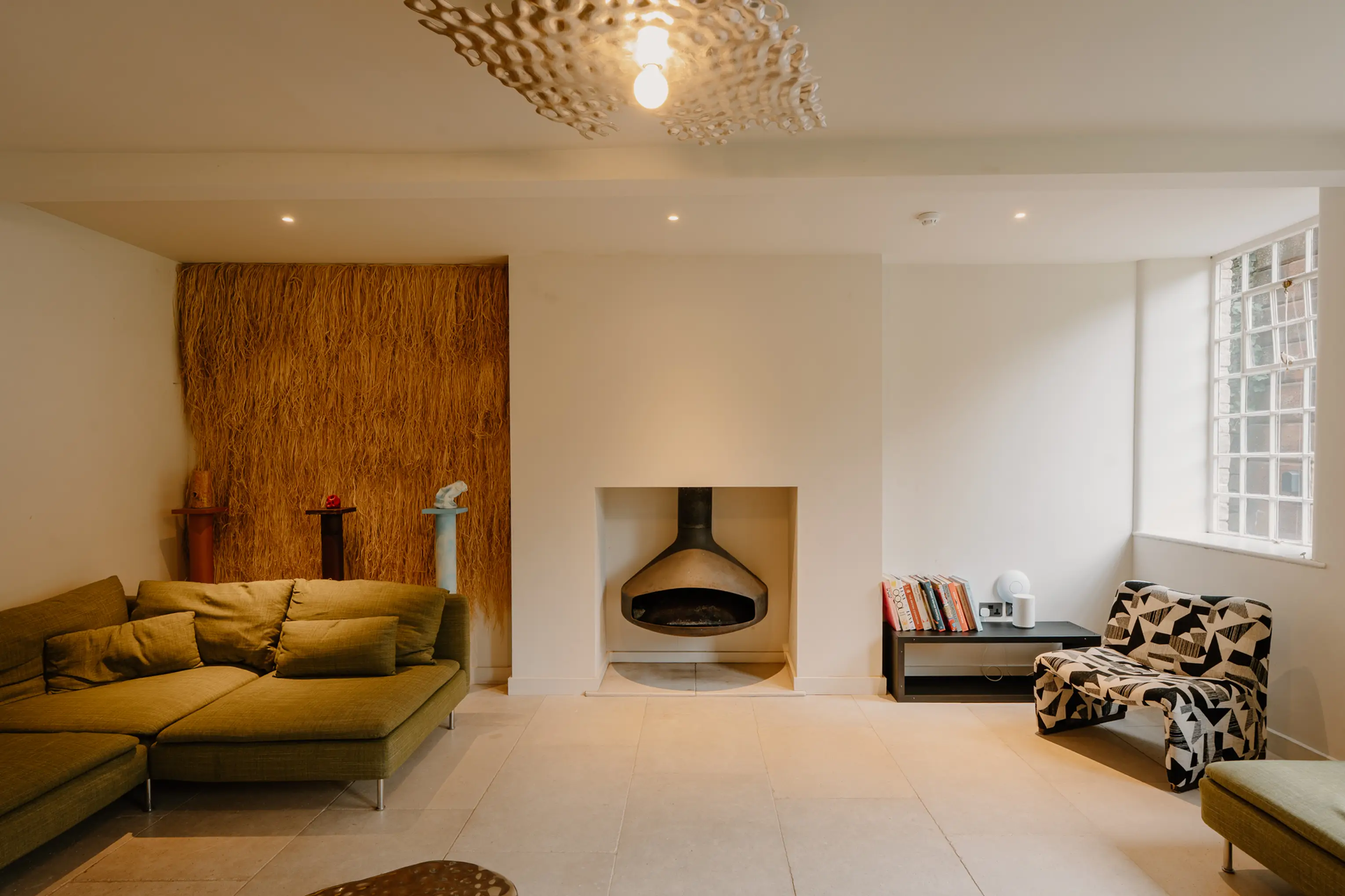 Lounge at ARC Peaks with a suspended fireplace and sofas in a bright open space