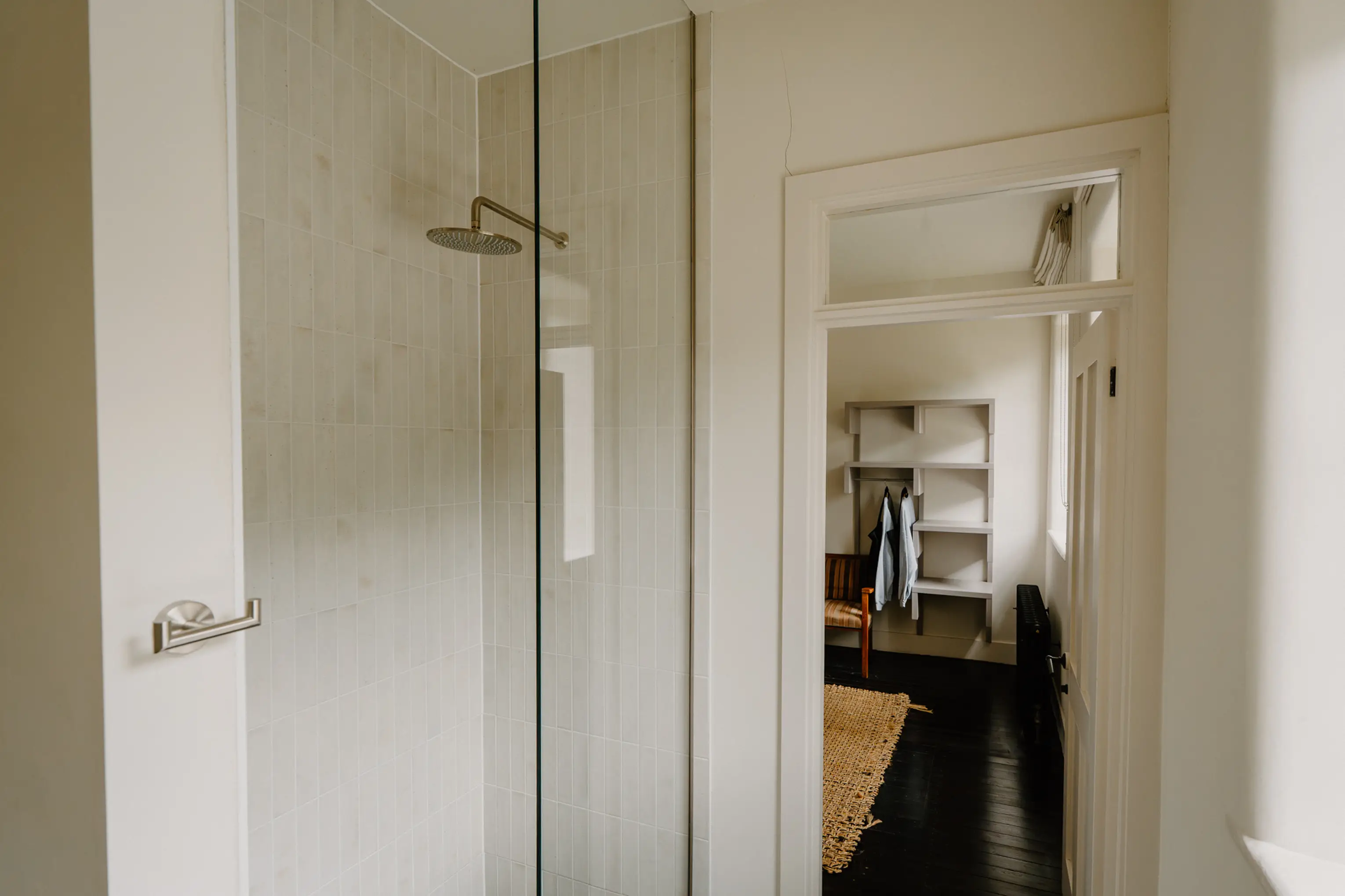 Walk-in shower with a glass screen beside the bedroom at ARC Peaks
