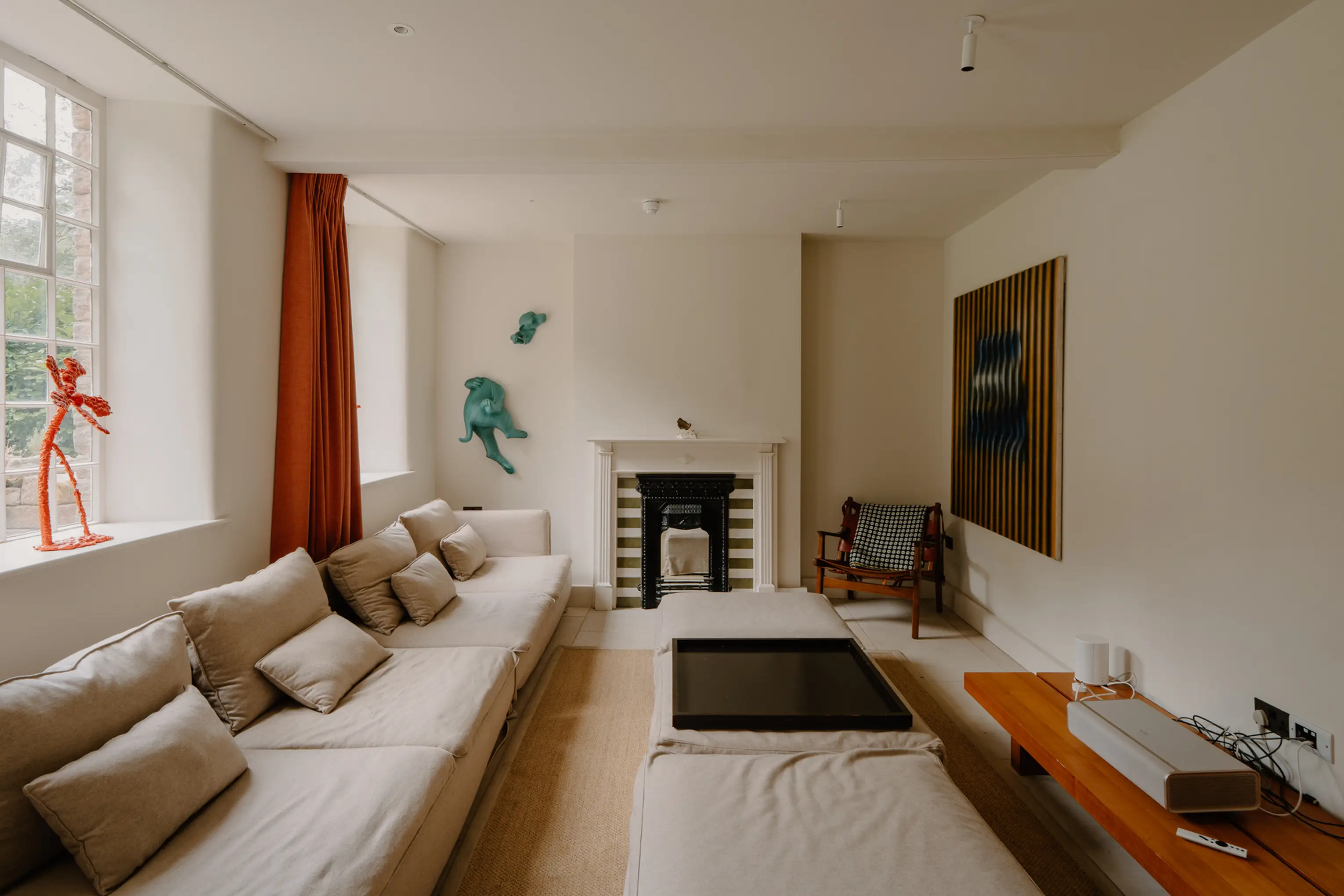 Snug at ARC Peaks with a sofa, fireplace and artwork