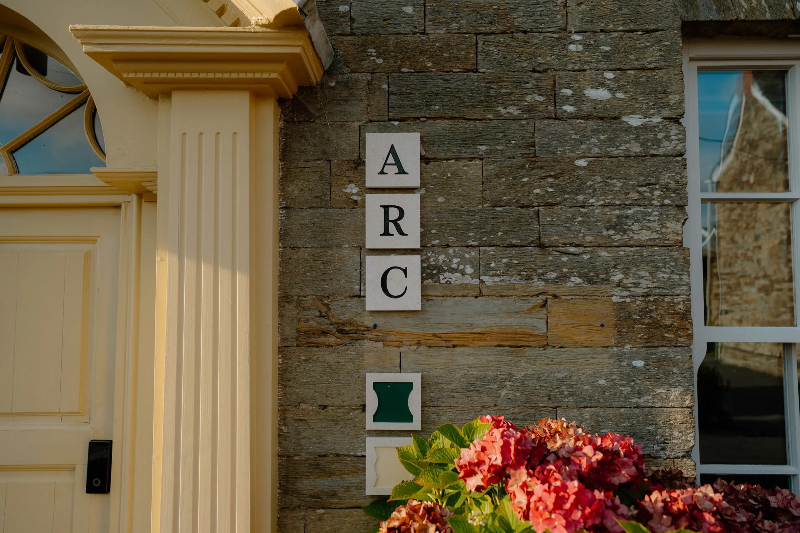 ARC signage and a fresh floral arrangement at the entrance to ARC Padstow