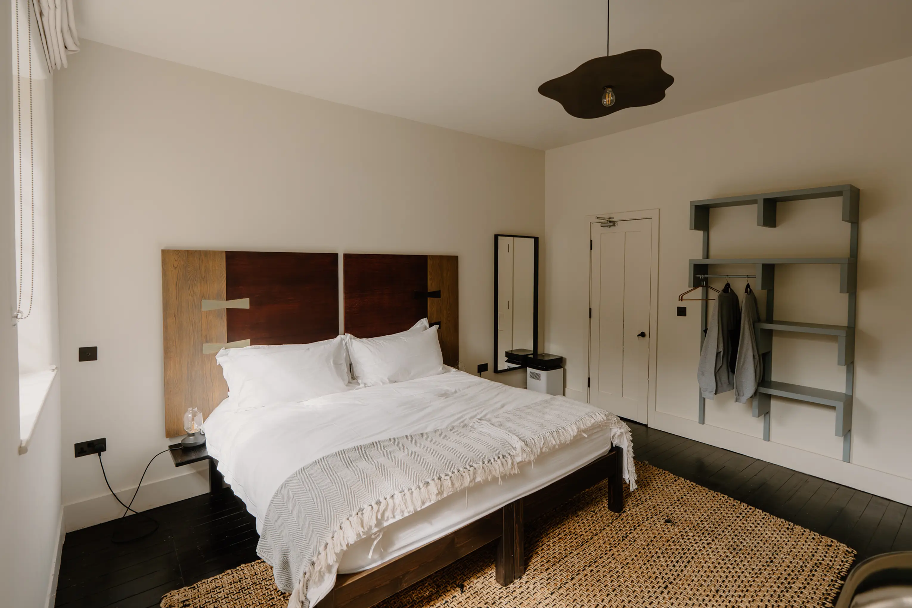 Superking bedroom at ARC Peaks with a dark wood headboard and an exposed wardrobe