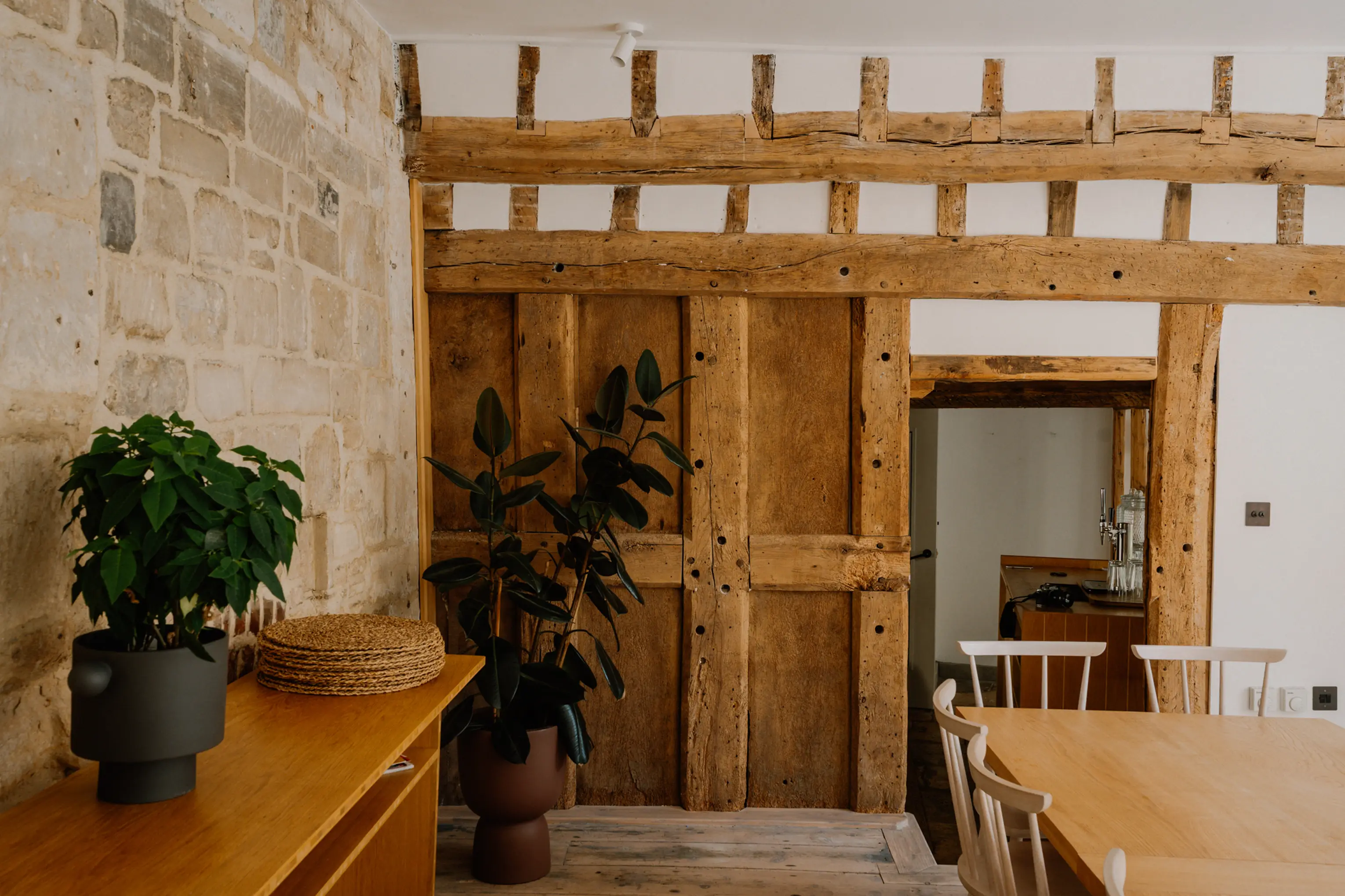 Kitchen and dining space at ARC Painswick with a timber island and exposed beams