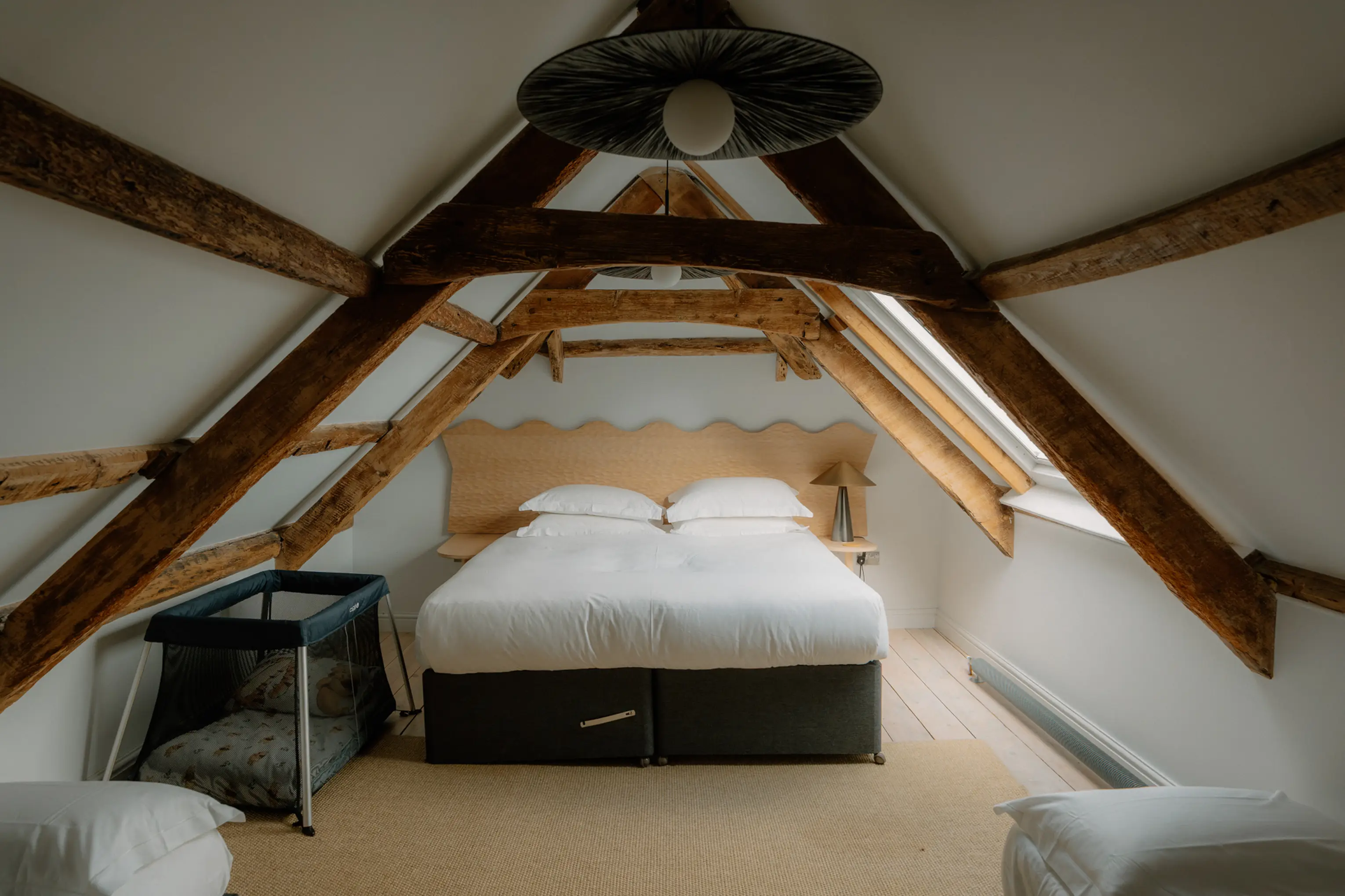 Attic double bedroom at ARC Padstow framed by exposed A-frame oak beams