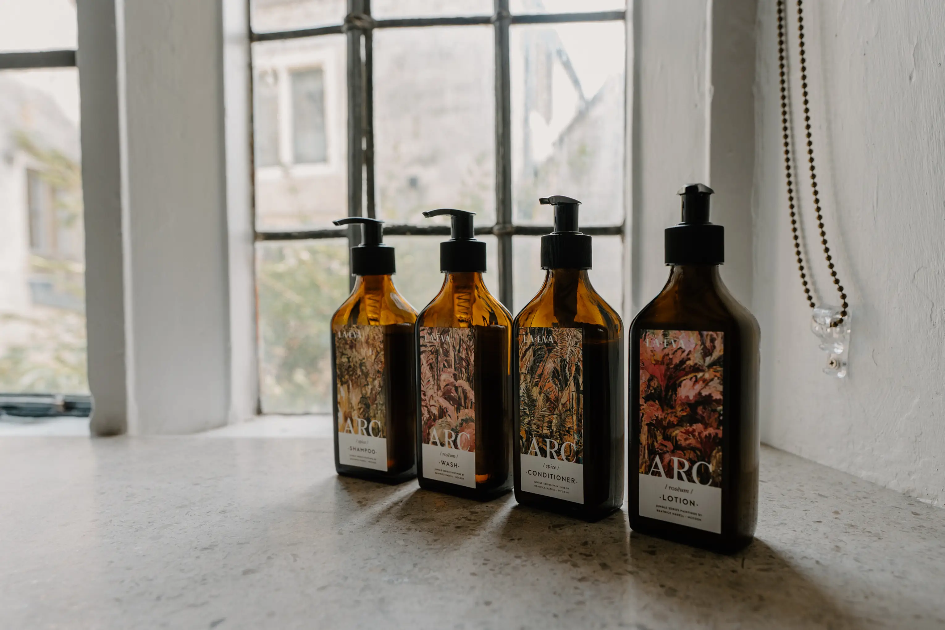 ARC bespoke amber toiletry bottles on a windowsill at ARC Painswick