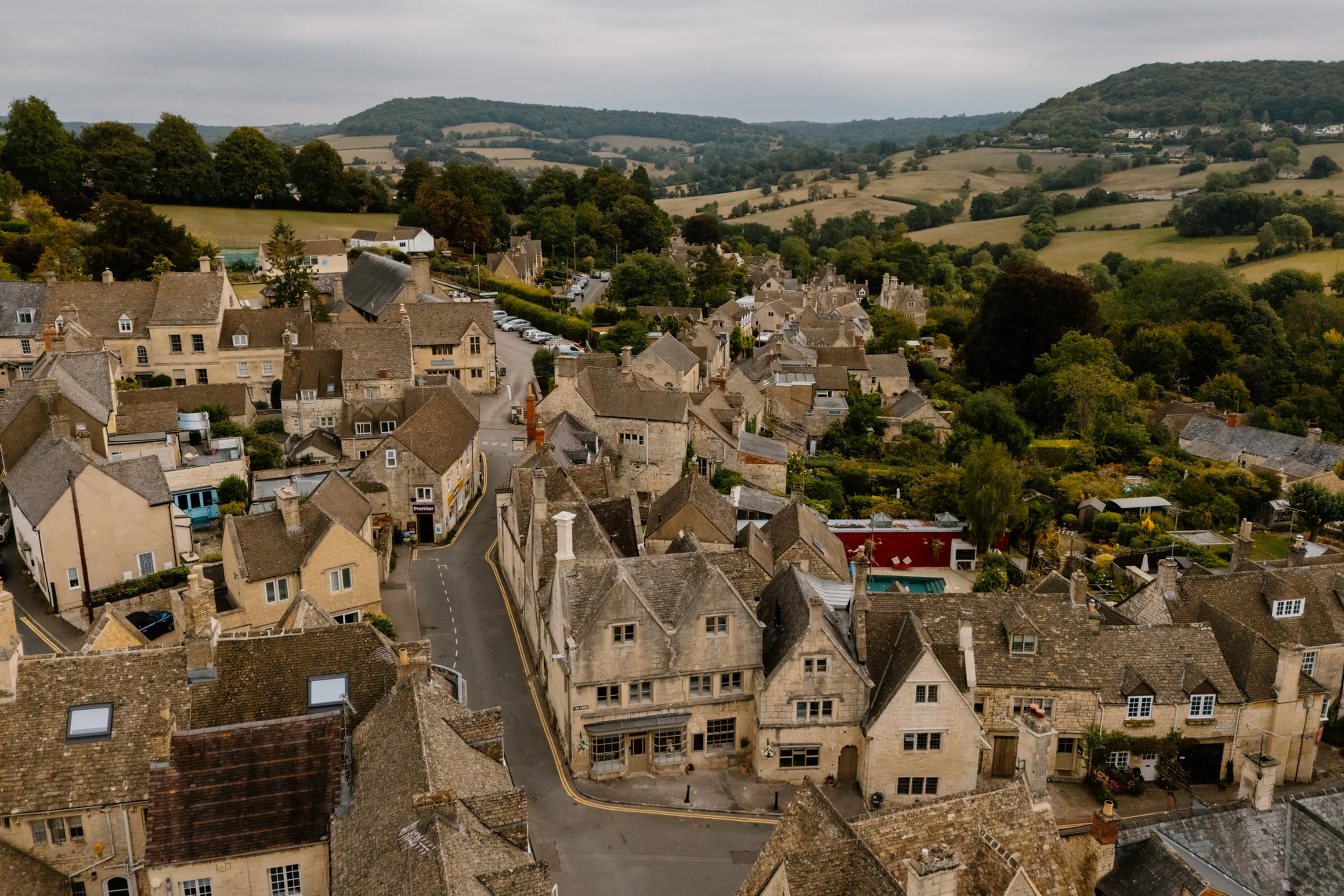 Aerial view over Painswick village rooftops and the parish church in the Cotswolds