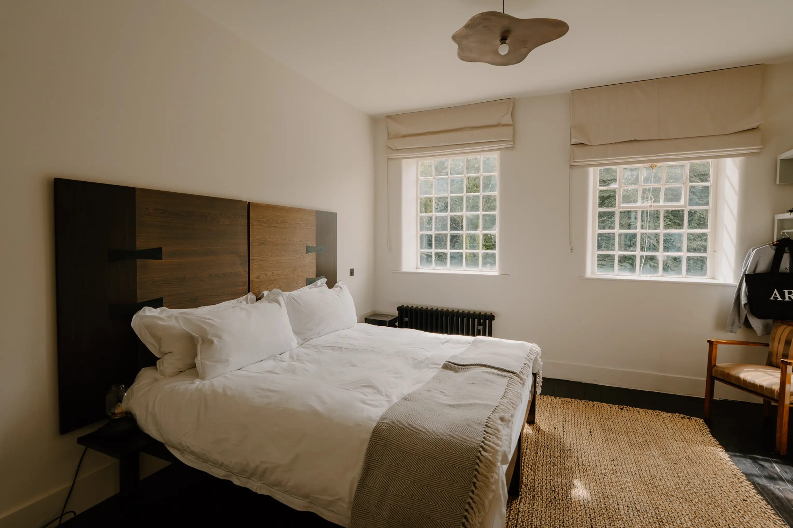 Superking bedroom at ARC Peaks with an upholstered headboard and bright windows