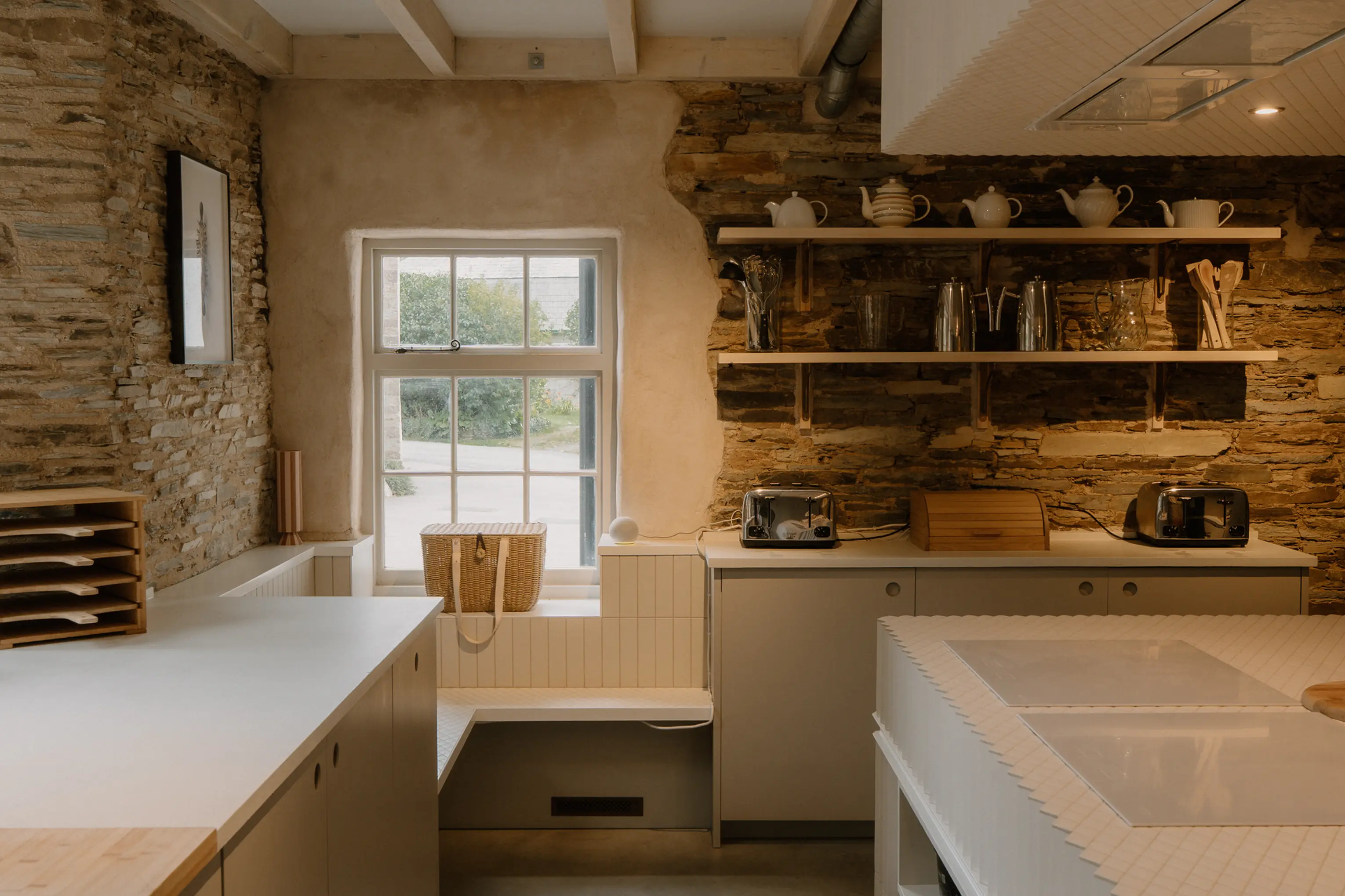 Kitchen corner at ARC Padstow with white modern units and open shelving