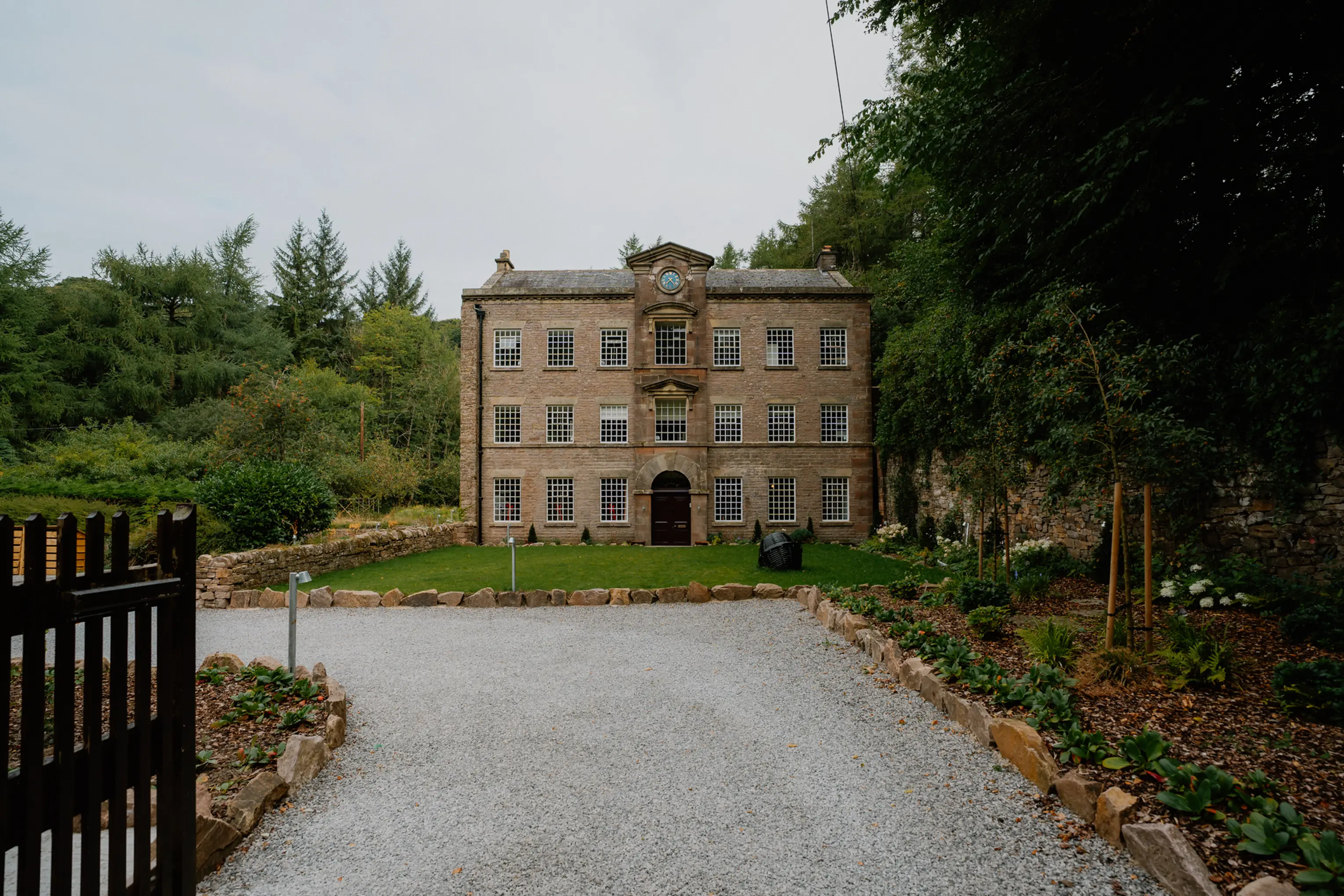 The Georgian stone house at ARC Peaks with a gravel drive and garden