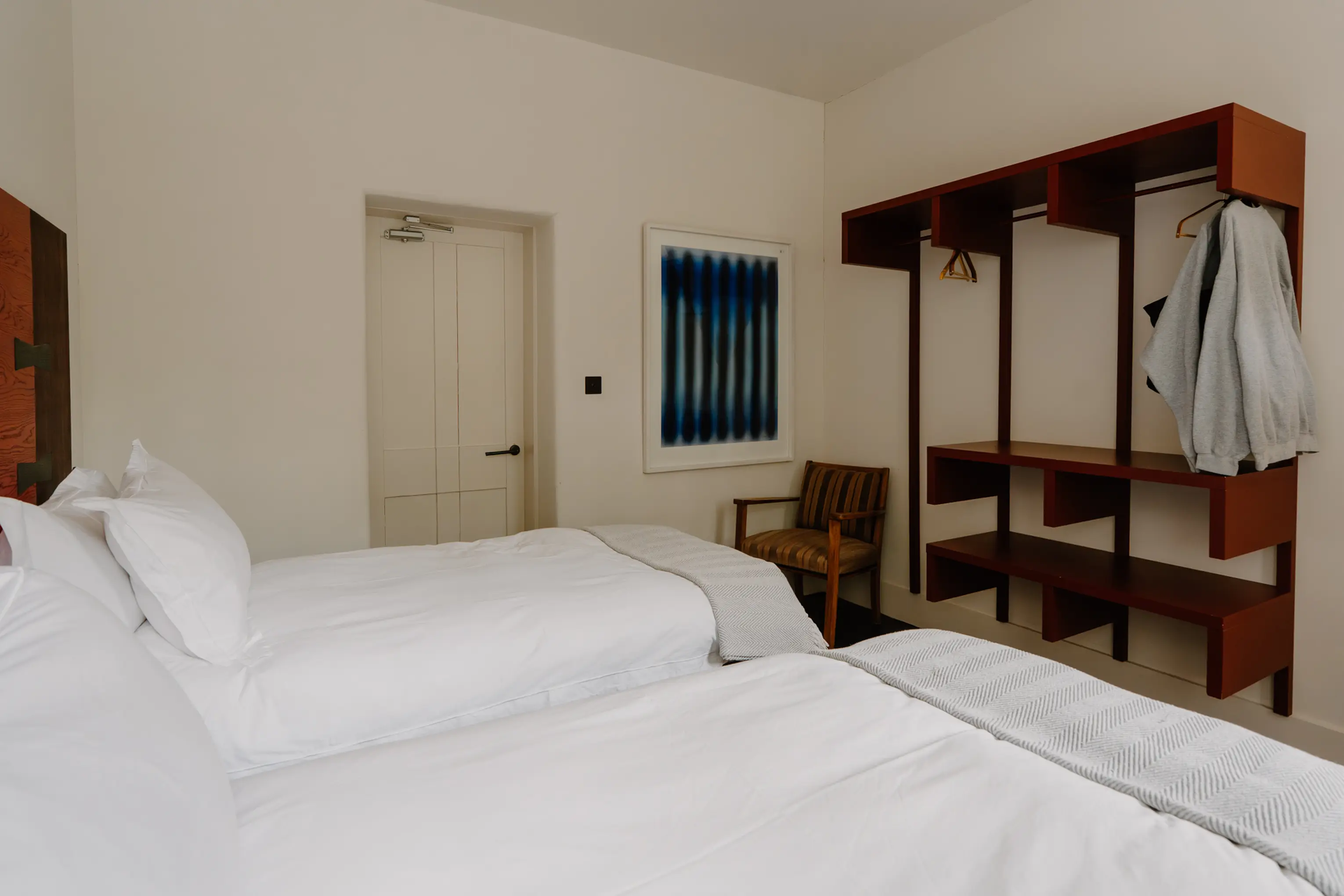 Superking bedroom at ARC Peaks with open timber shelving and a mirror