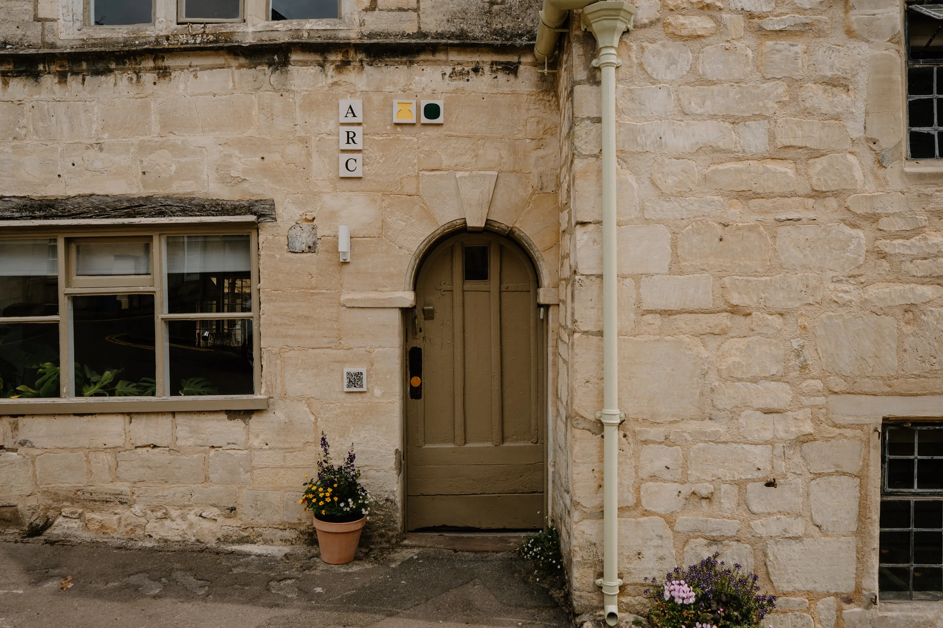 Arched stone doorway entrance to ARC Painswick in Cotswold stone