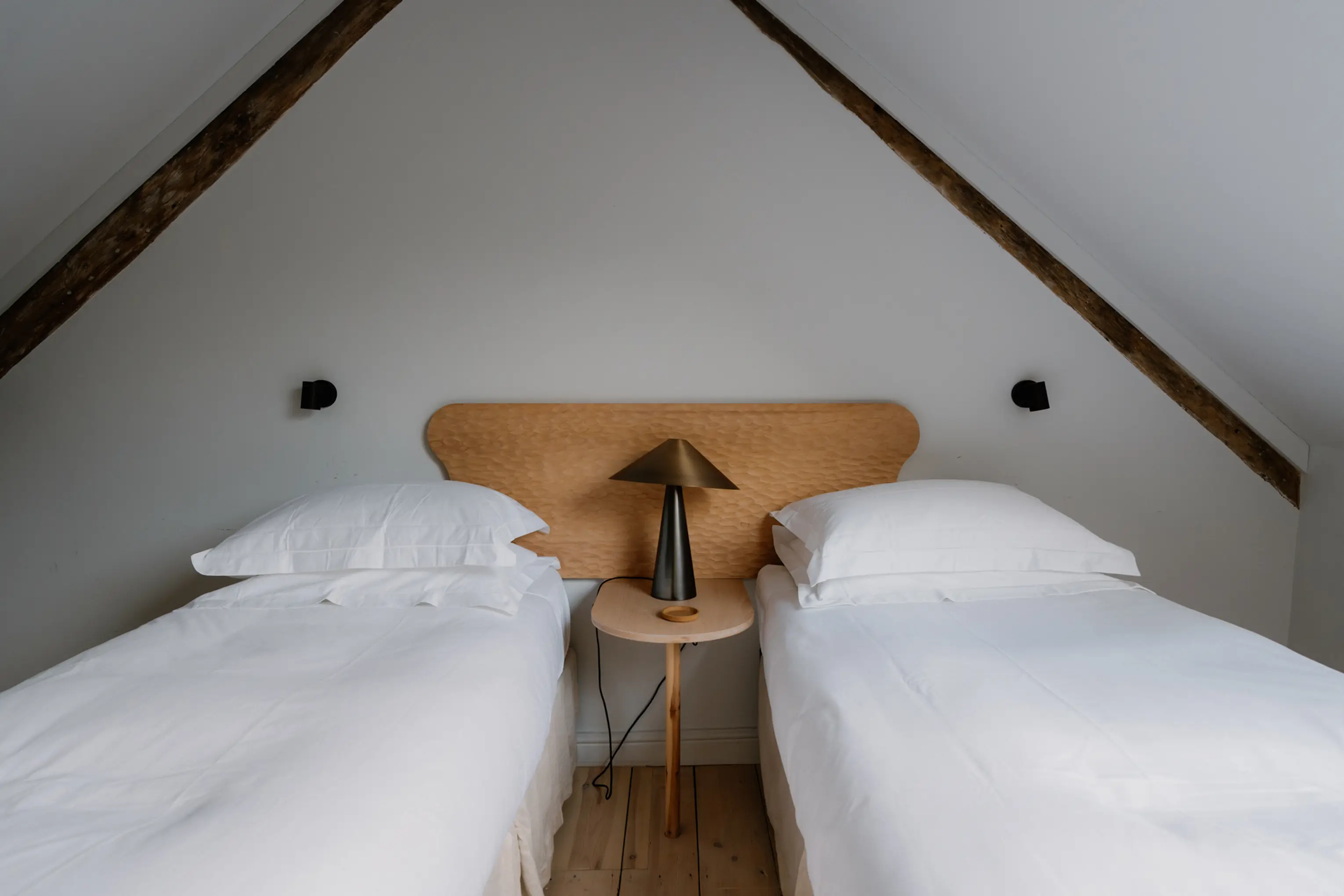 Twin attic bedroom at ARC Padstow with two single beds under a sloping ceiling
