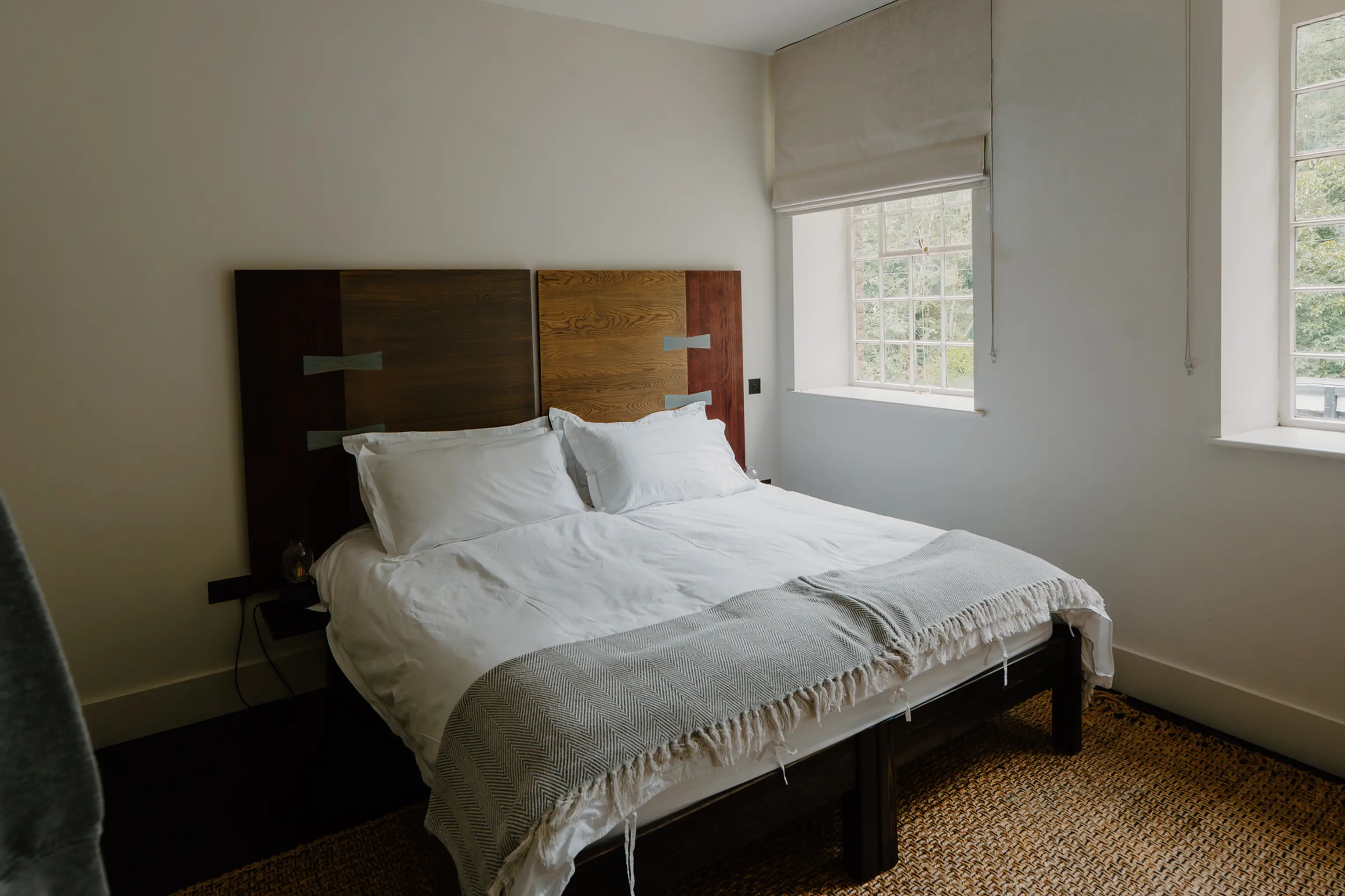Superking bedroom at ARC Peaks with a dark wood headboard and a window