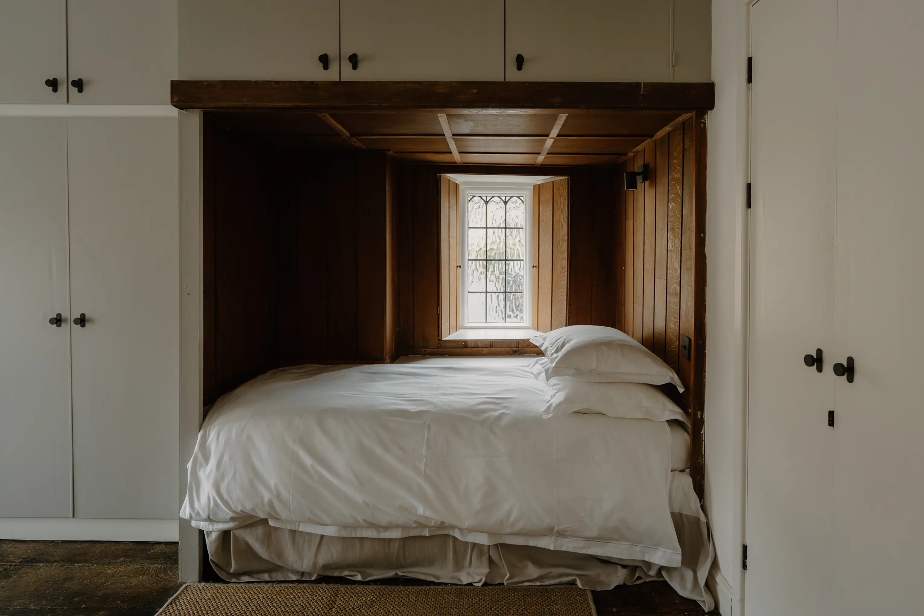 Superking bedroom at ARC Painswick with fitted wardrobes and a window