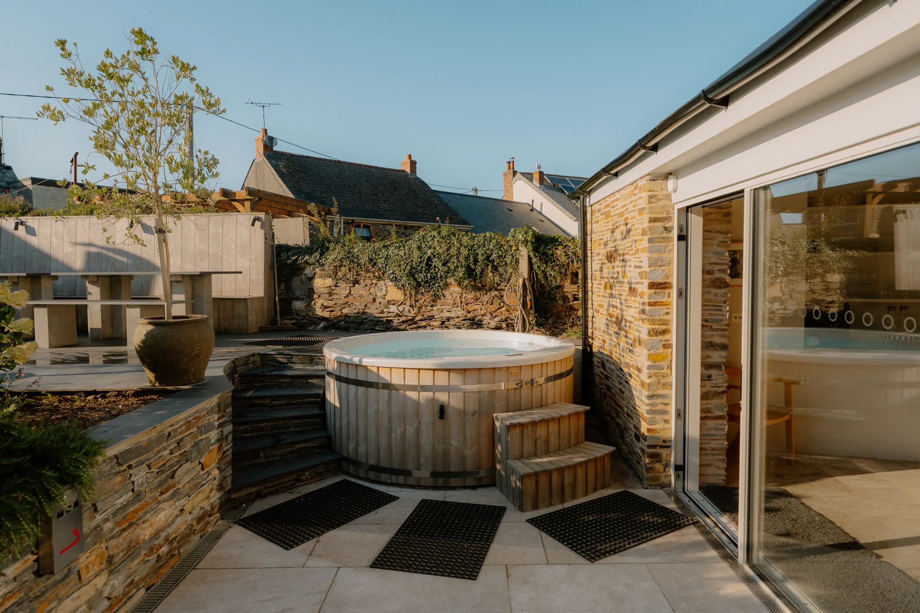 Wood-fired hot tub on the decked courtyard at ARC Padstow