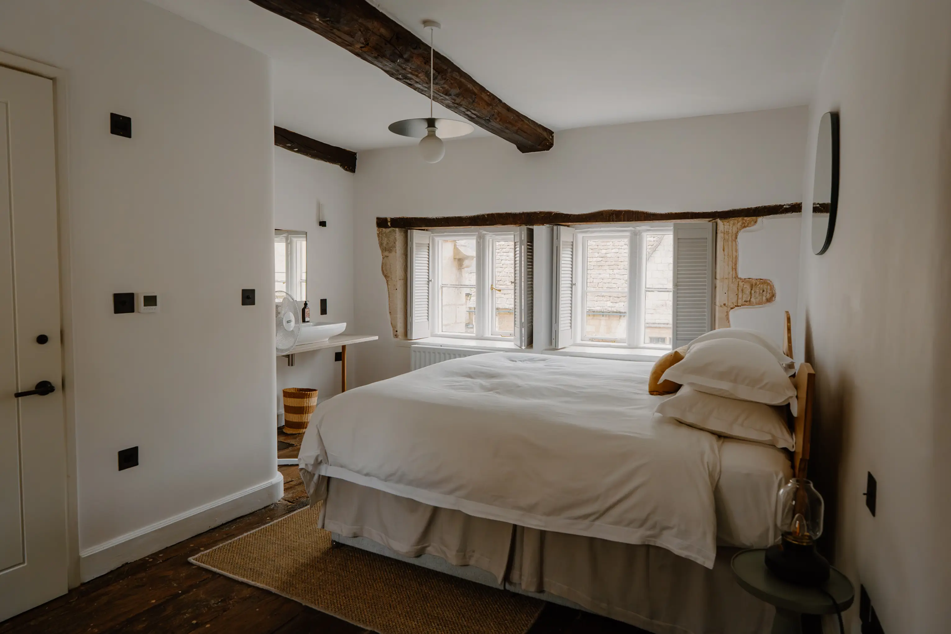 Superking bedroom at ARC Painswick with exposed beams and a window