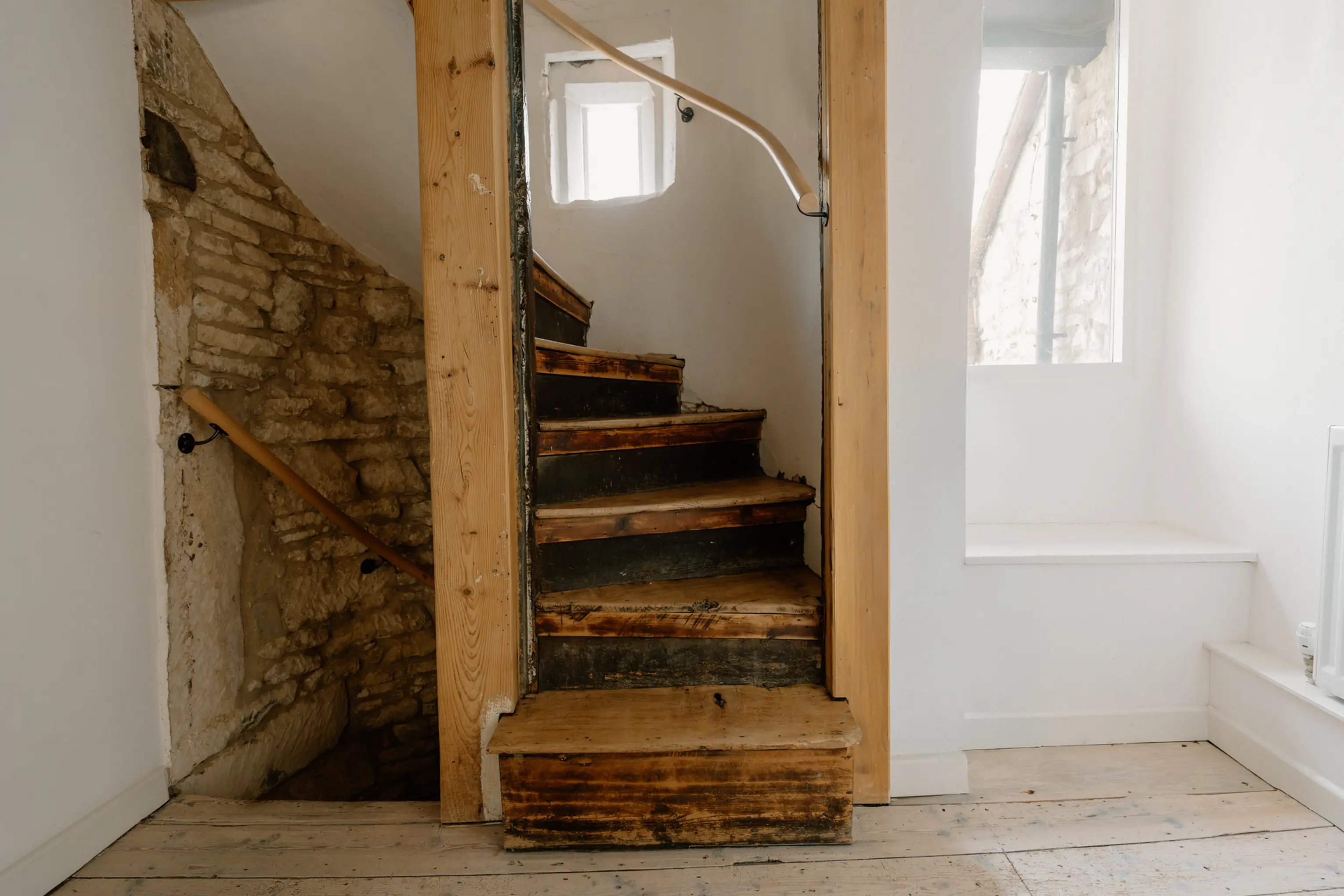 Timber staircase rising to an attic room at ARC Painswick