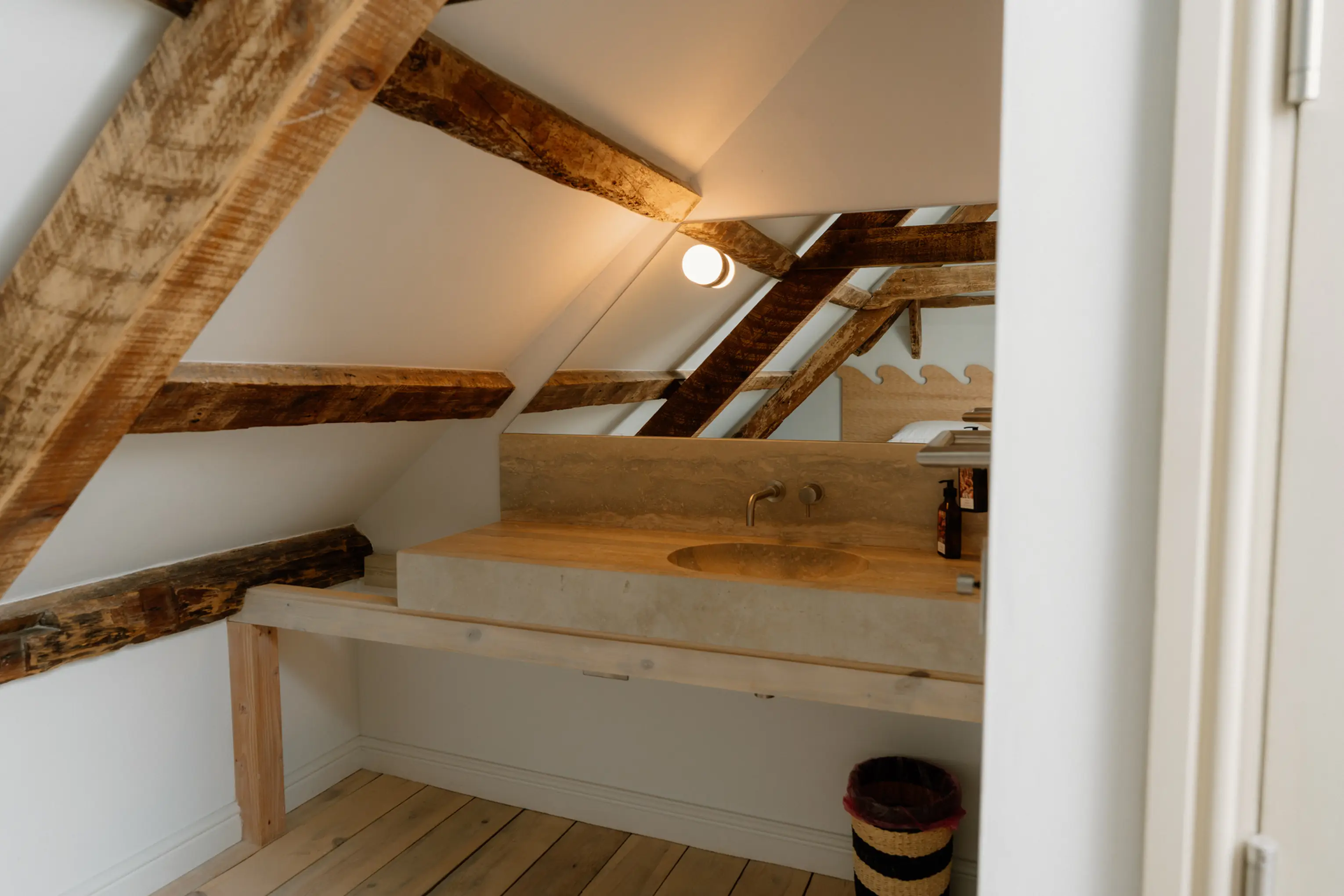 Built-in sink tucked under the exposed eaves beams at ARC Padstow