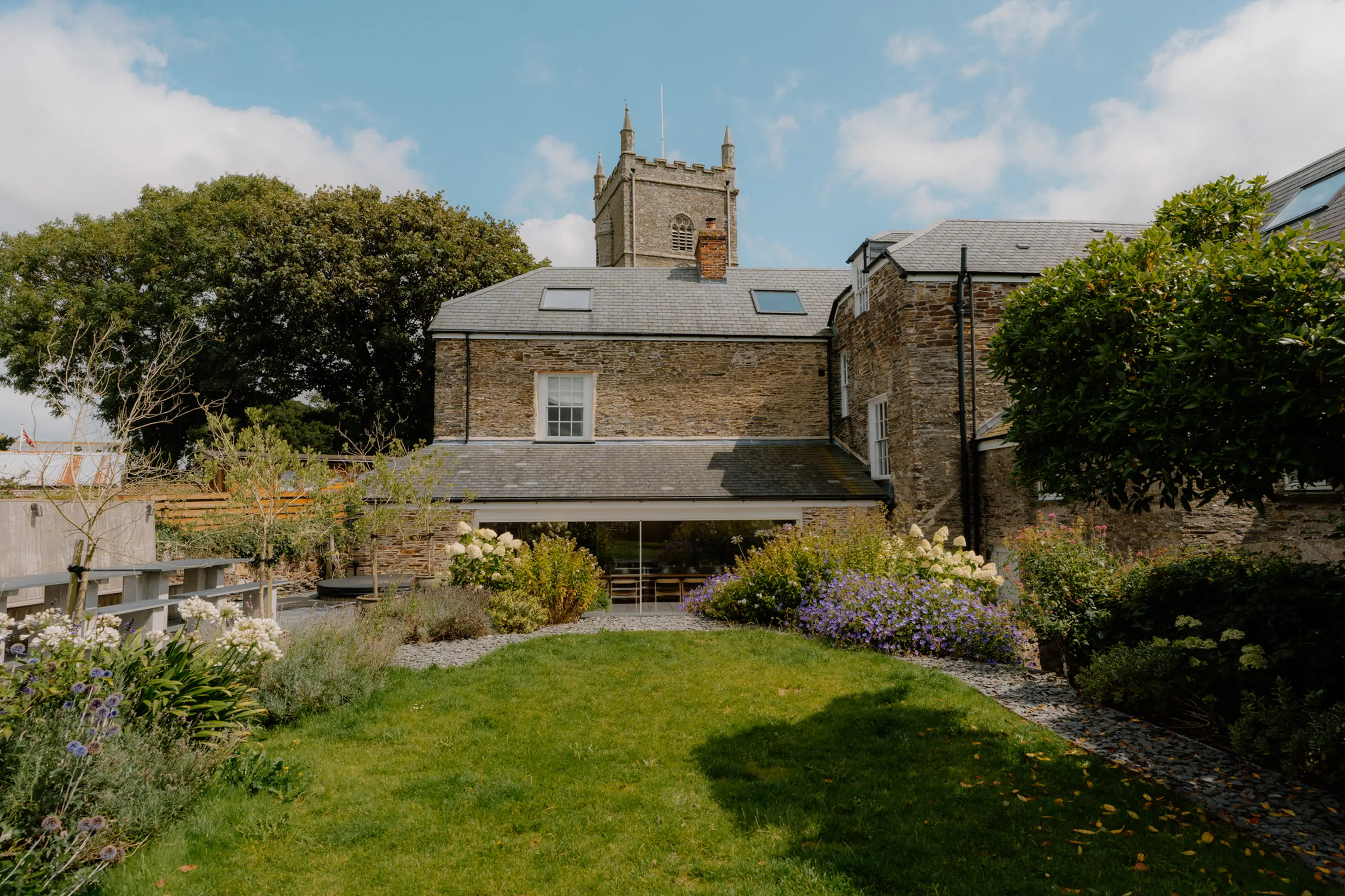 Aerial view of ARC Padstow and its gardens beside the village church near Padstow
