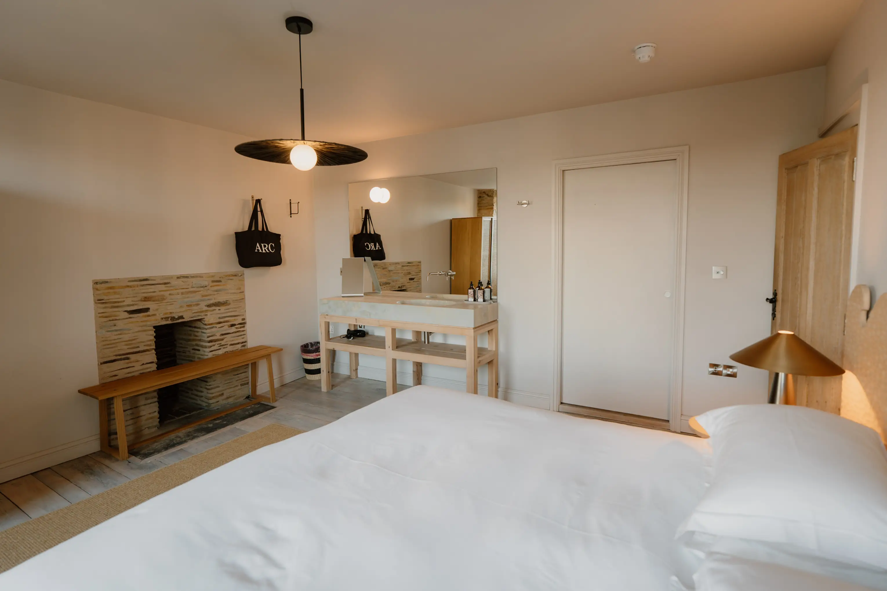 Neutral-toned superking bedroom at ARC Padstow with pendant lights and a sideboard