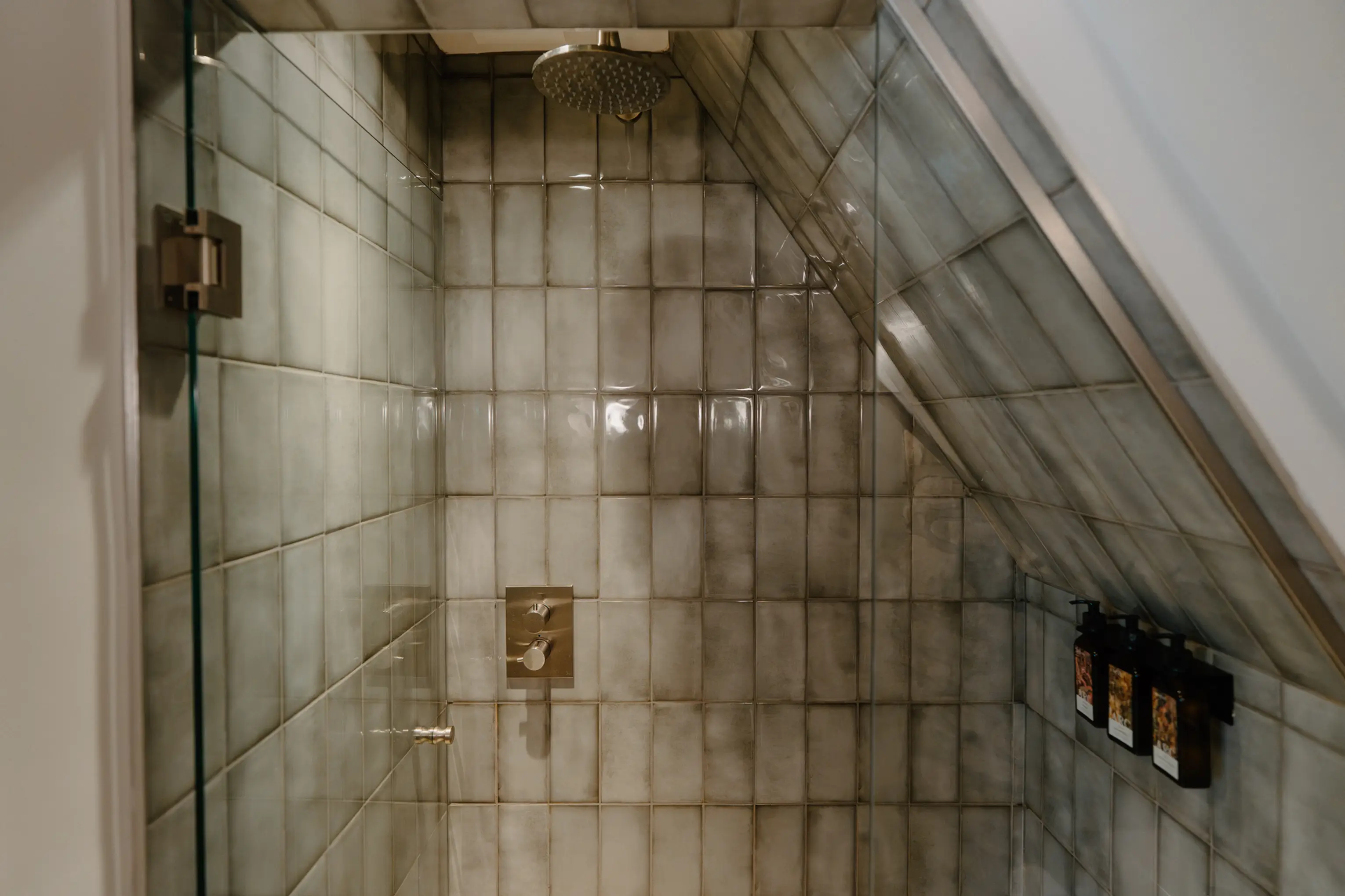 Tiled walk-in shower with a glass screen at ARC Painswick