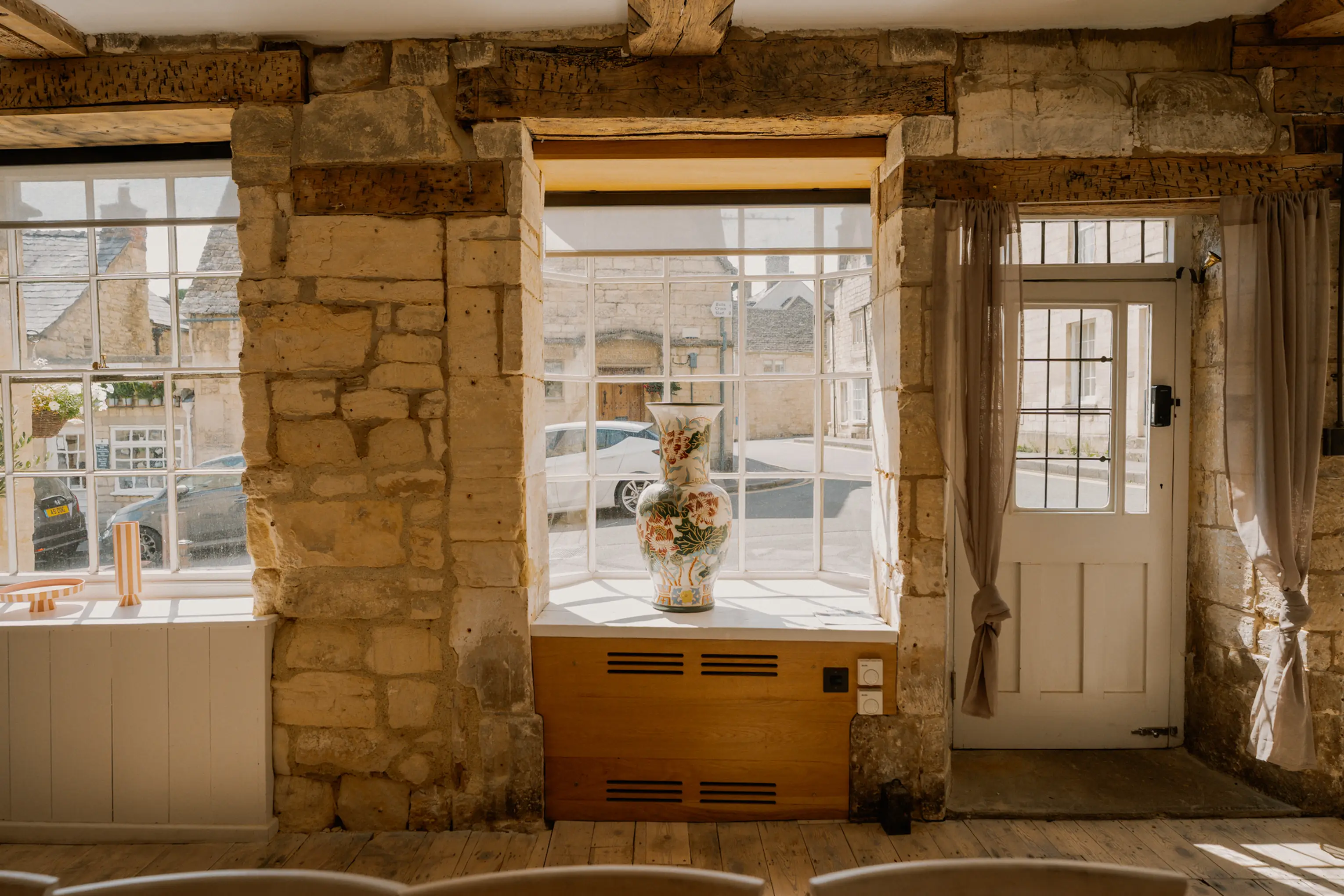 Stone-walled room at ARC Painswick with a window seat and timber detailing