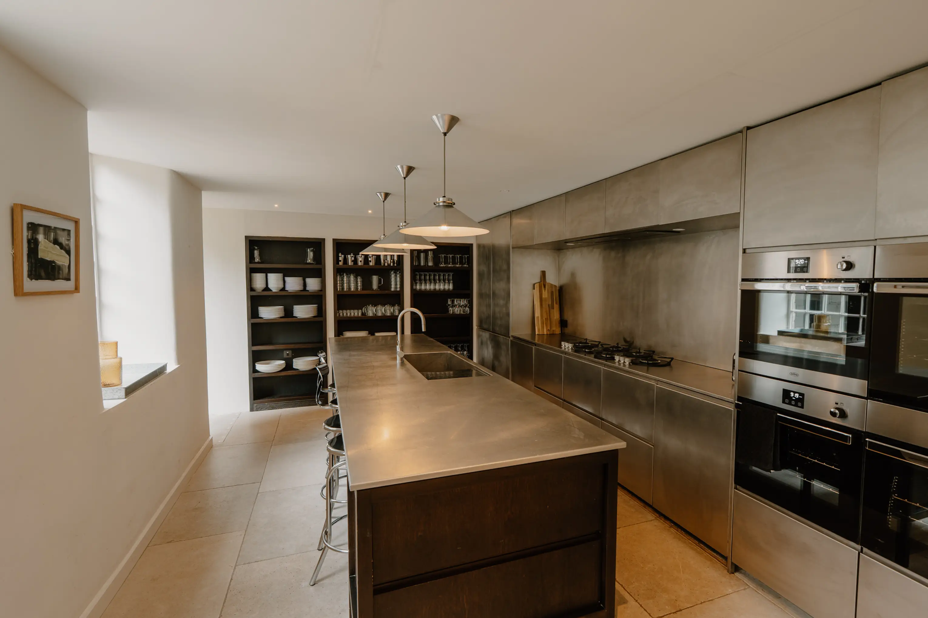 Kitchen at ARC Peaks with a central island, dark units and Miele appliances
