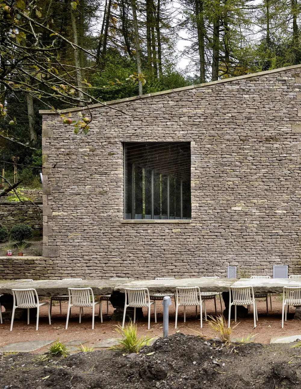 A grand outdoor table with seating for groups stays up to 40 sculpted from reclaimed stone excavated onsite.