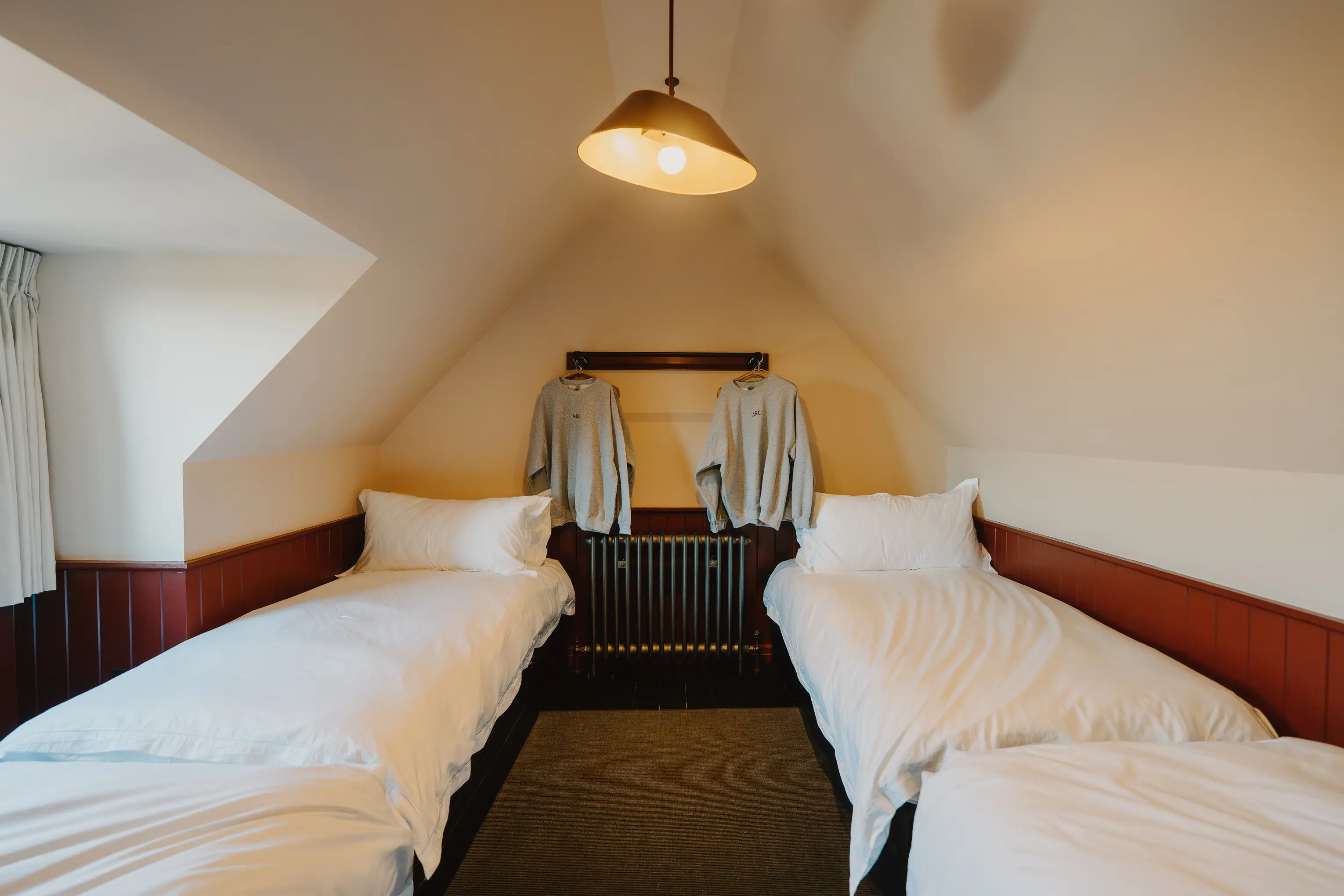Twin attic bedroom at ARC Thorpeness with two single beds under a sloping ceiling