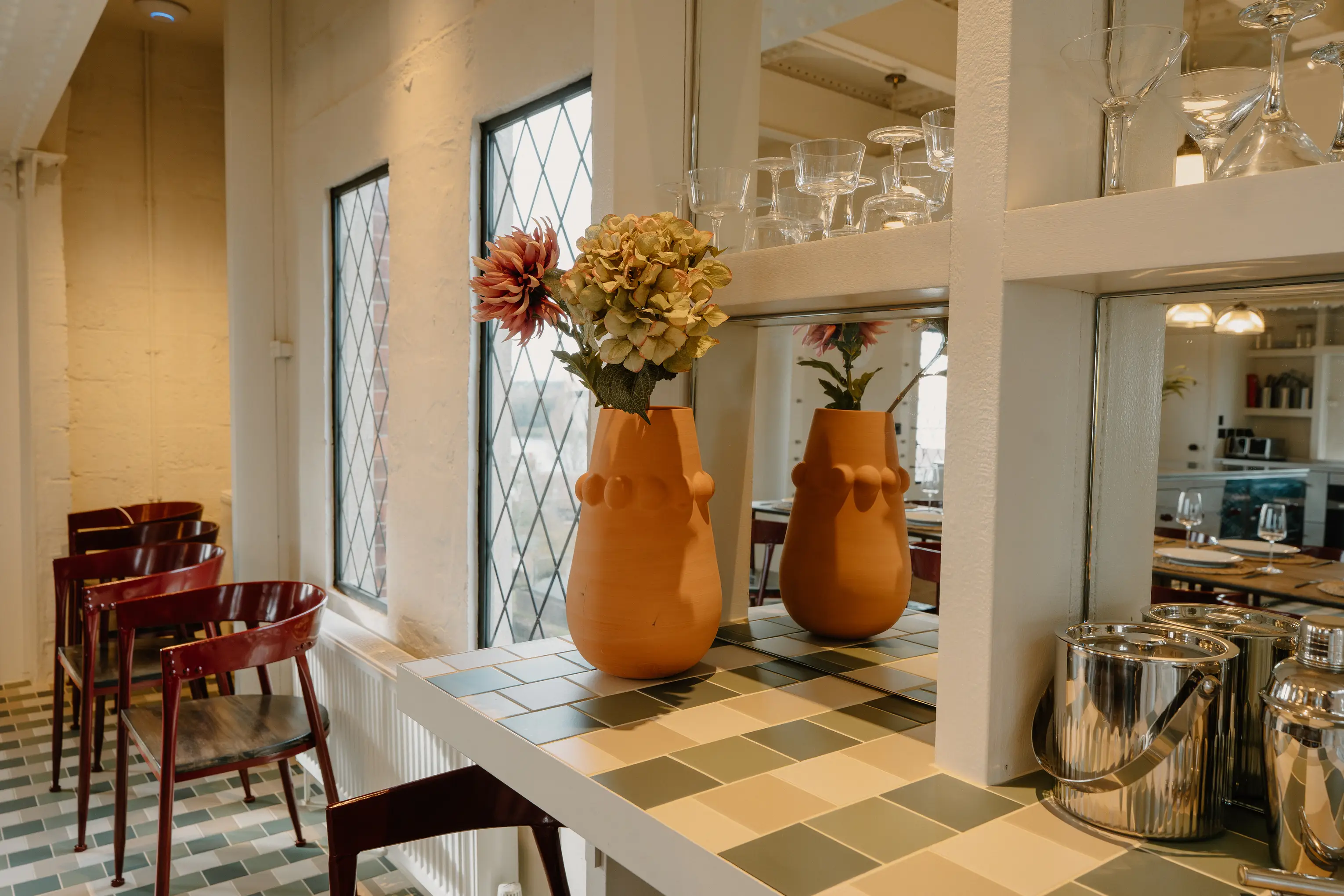 Bar area in ARC Thorpness with decorative tiling, glasses and cocktail equipment
