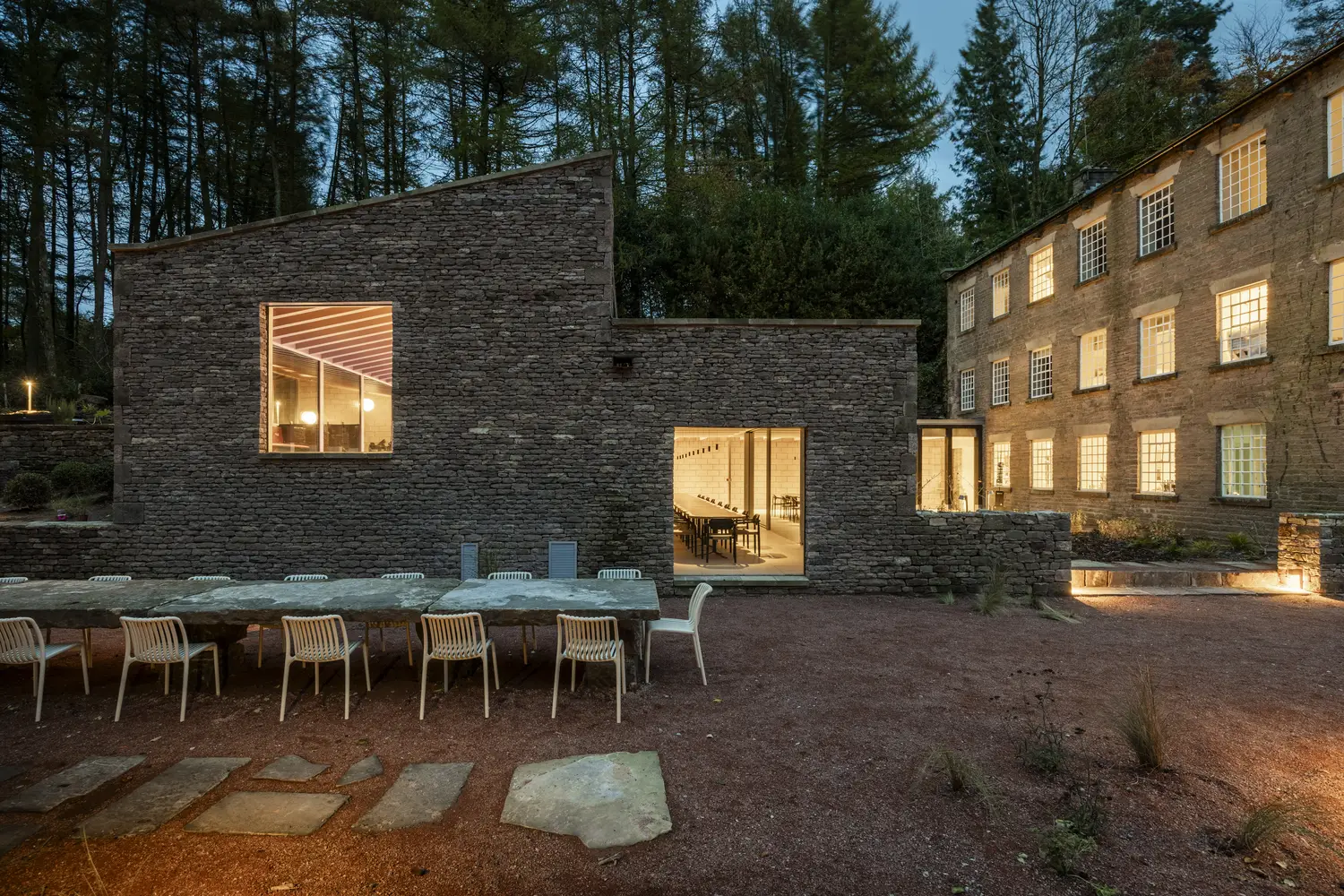 A photo looking in at one of the large dining tables accommodating 40 people available for group stays at ARC Peak District.